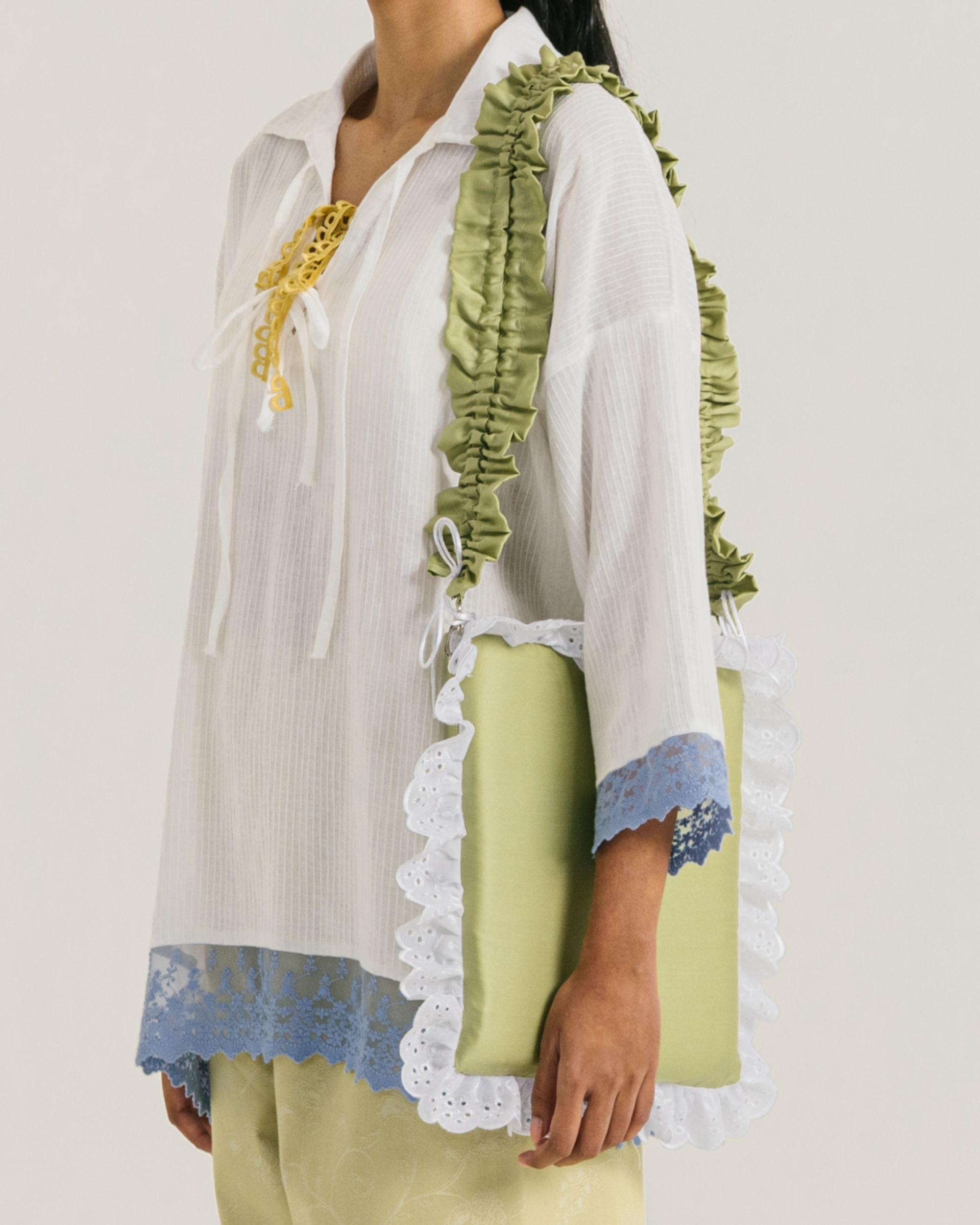 Image of Pillow Bag Medium, a pillow-like bag made from satin.