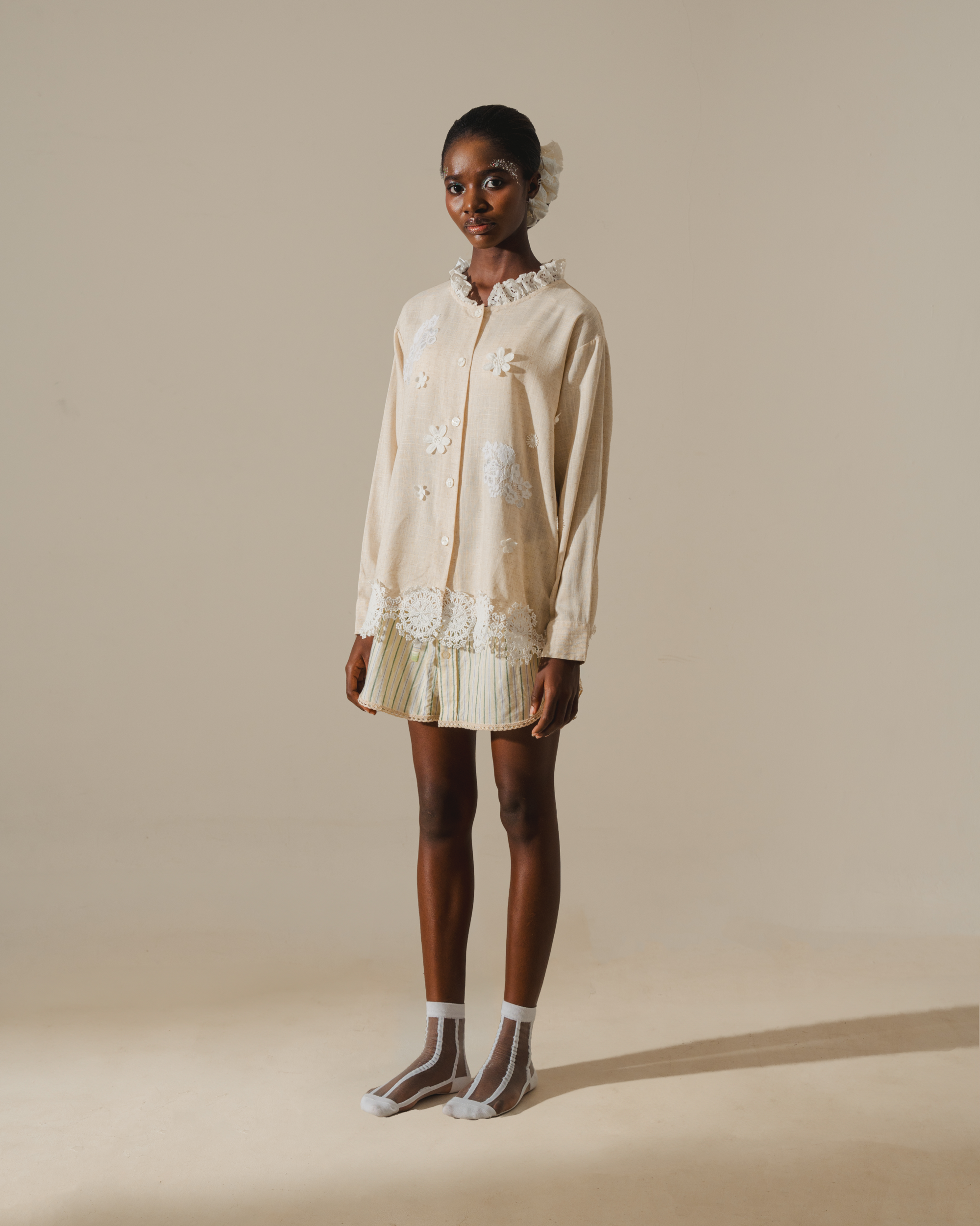 Image of Alette Embroidery Blouse, a longsleeve blouse made from deadstock linen, adorned with delicate lace detailing on the hem and neckline.