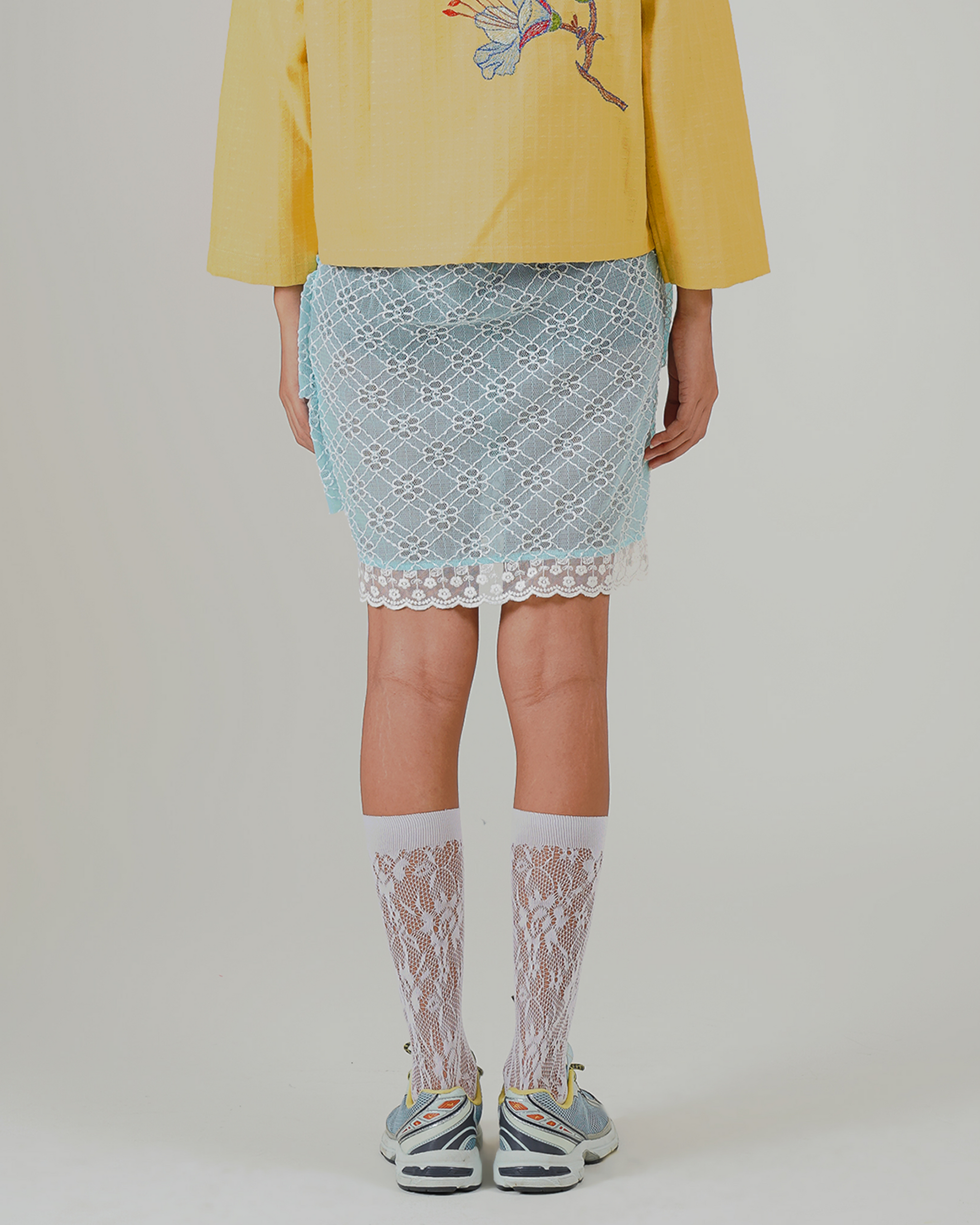 Image of Aruna Mini Ruffle Skirt Blue. a ruffle mini skirt made from lace and lined for coverage.