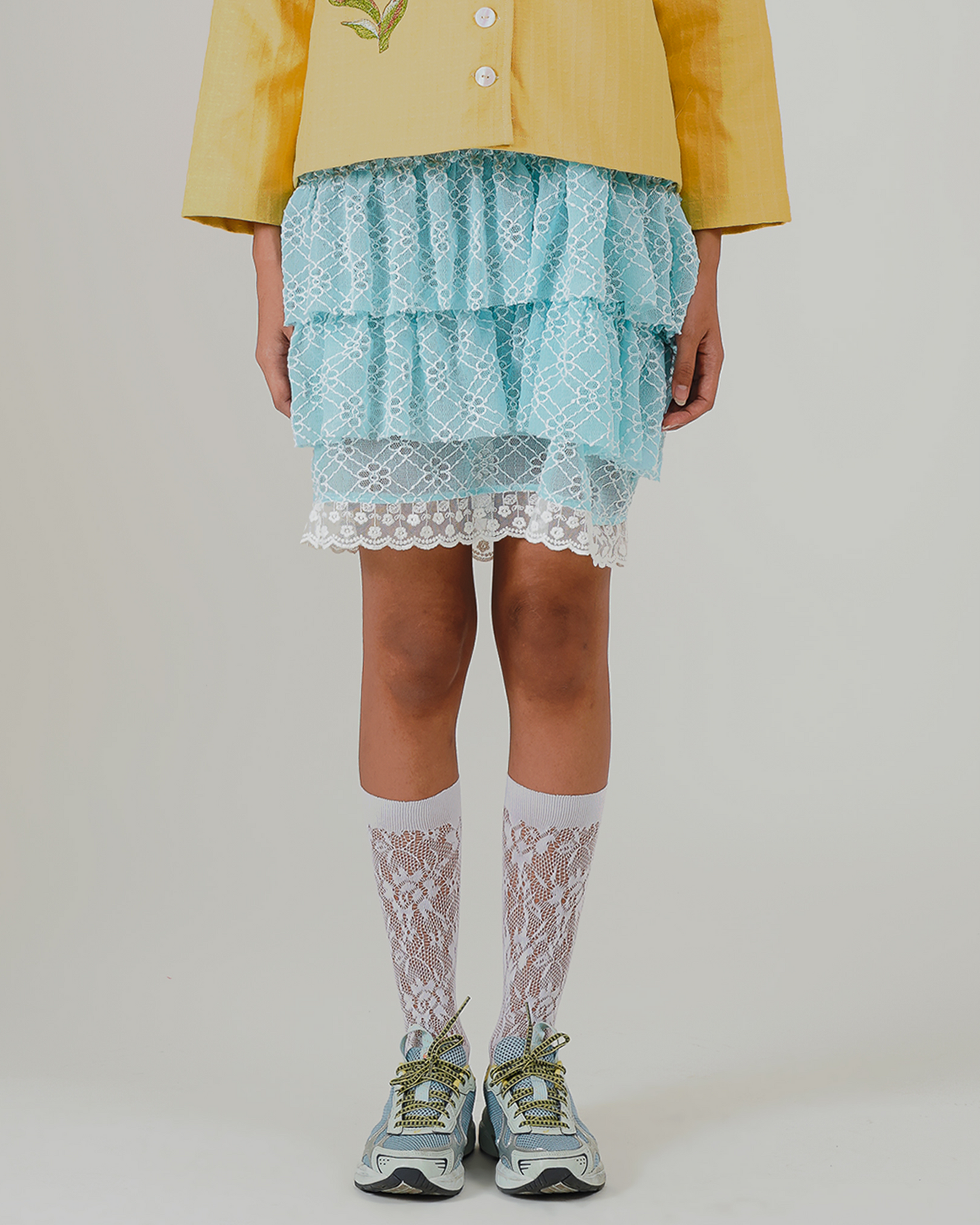 Image of Aruna Mini Ruffle Skirt Blue. a ruffle mini skirt made from lace and lined for coverage.