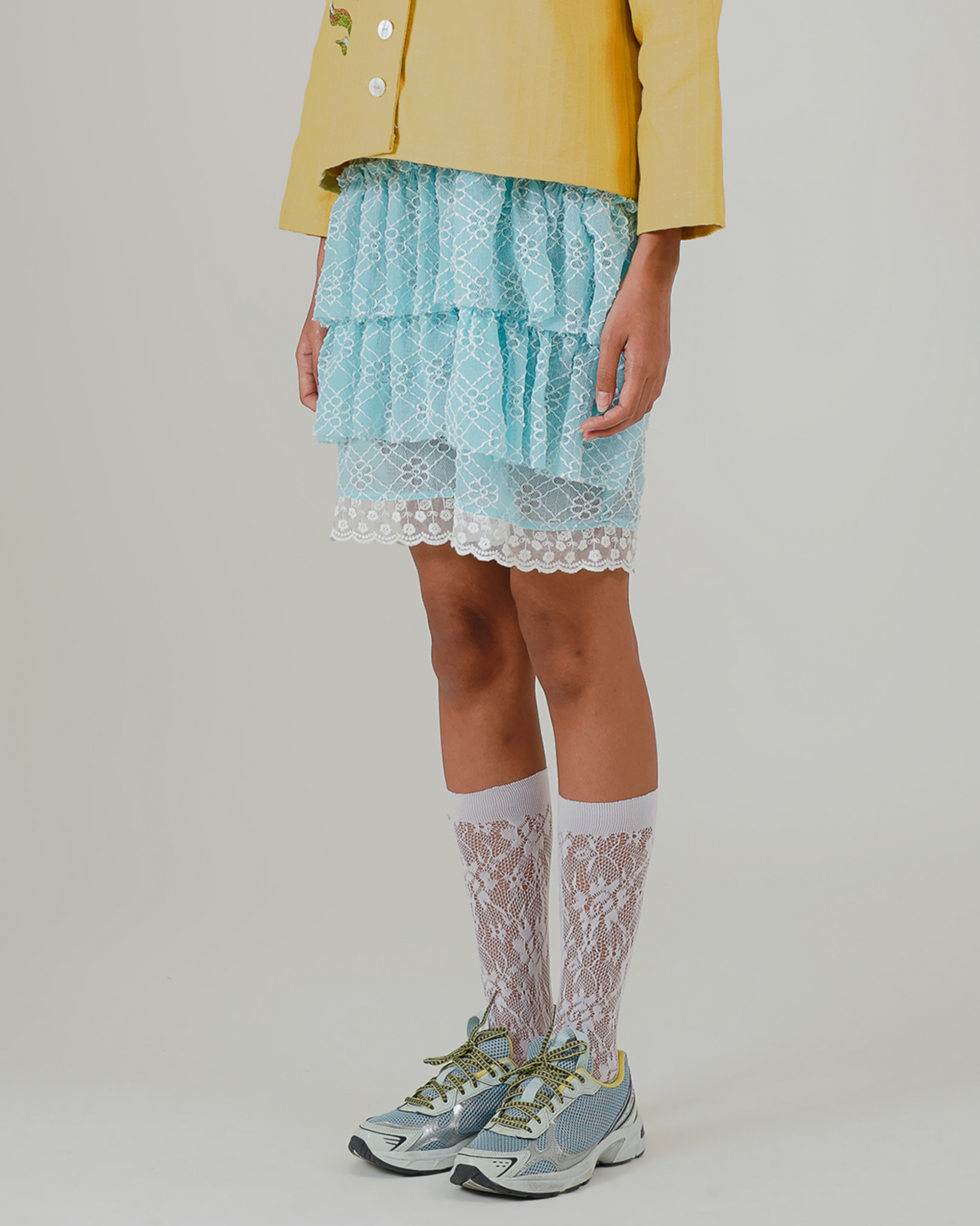 Image of Aruna Mini Ruffle Skirt Blue. a ruffle mini skirt made from lace and lined for coverage.