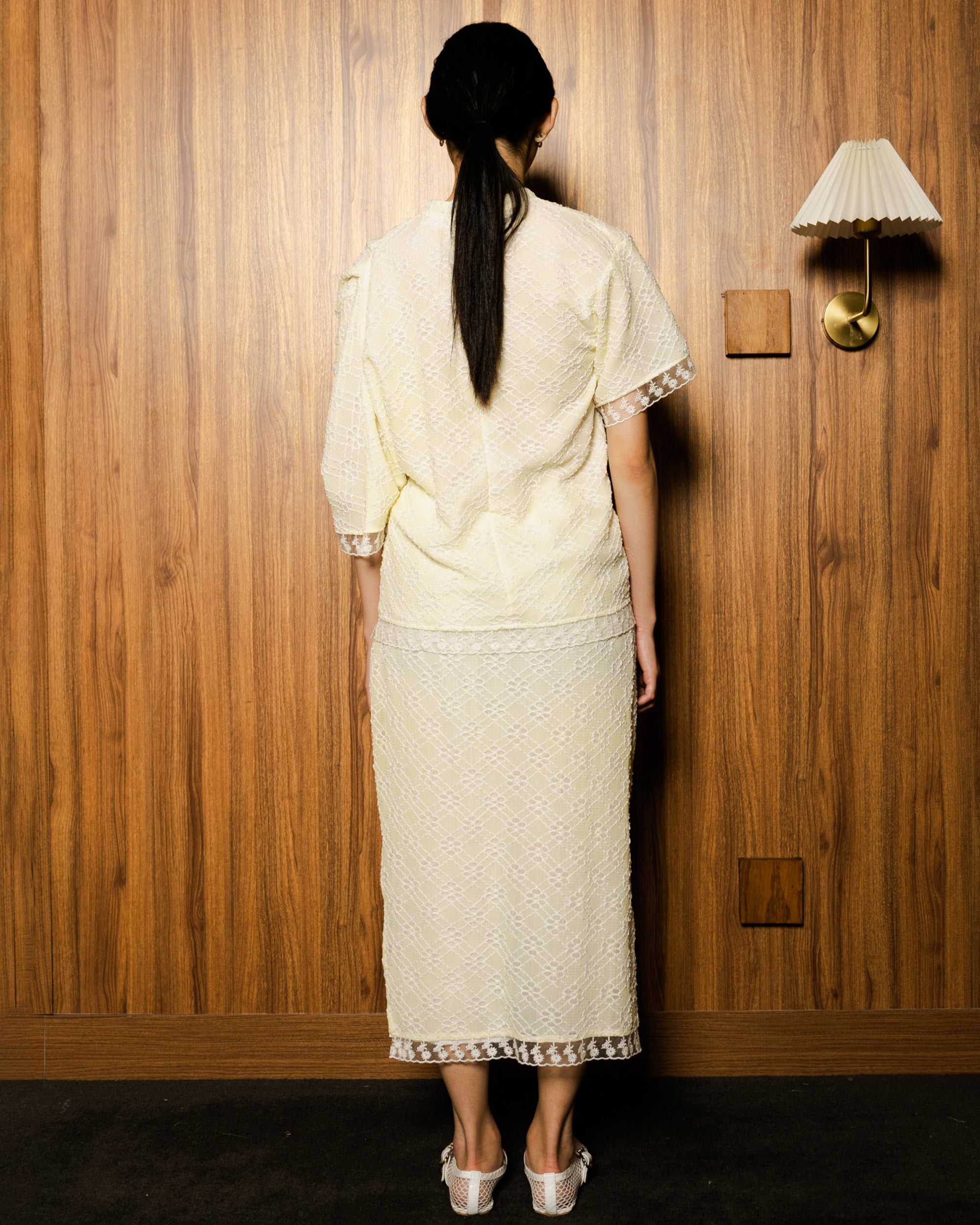 Image of Ava Blouse Yellow, an assymetric drape blouse made from embroidered lace.