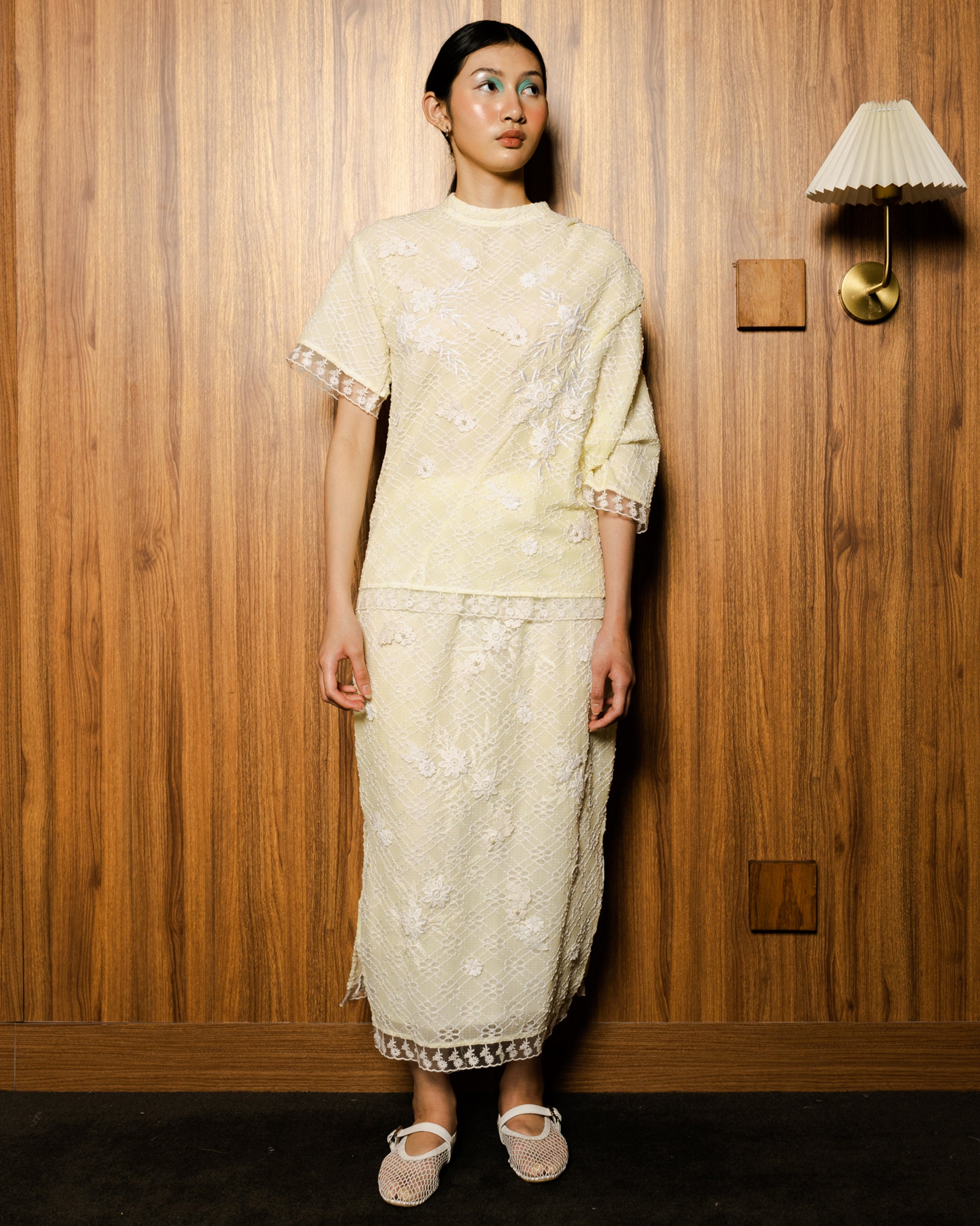 Image of Ava Blouse Yellow, an assymetric drape blouse made from embroidered lace.