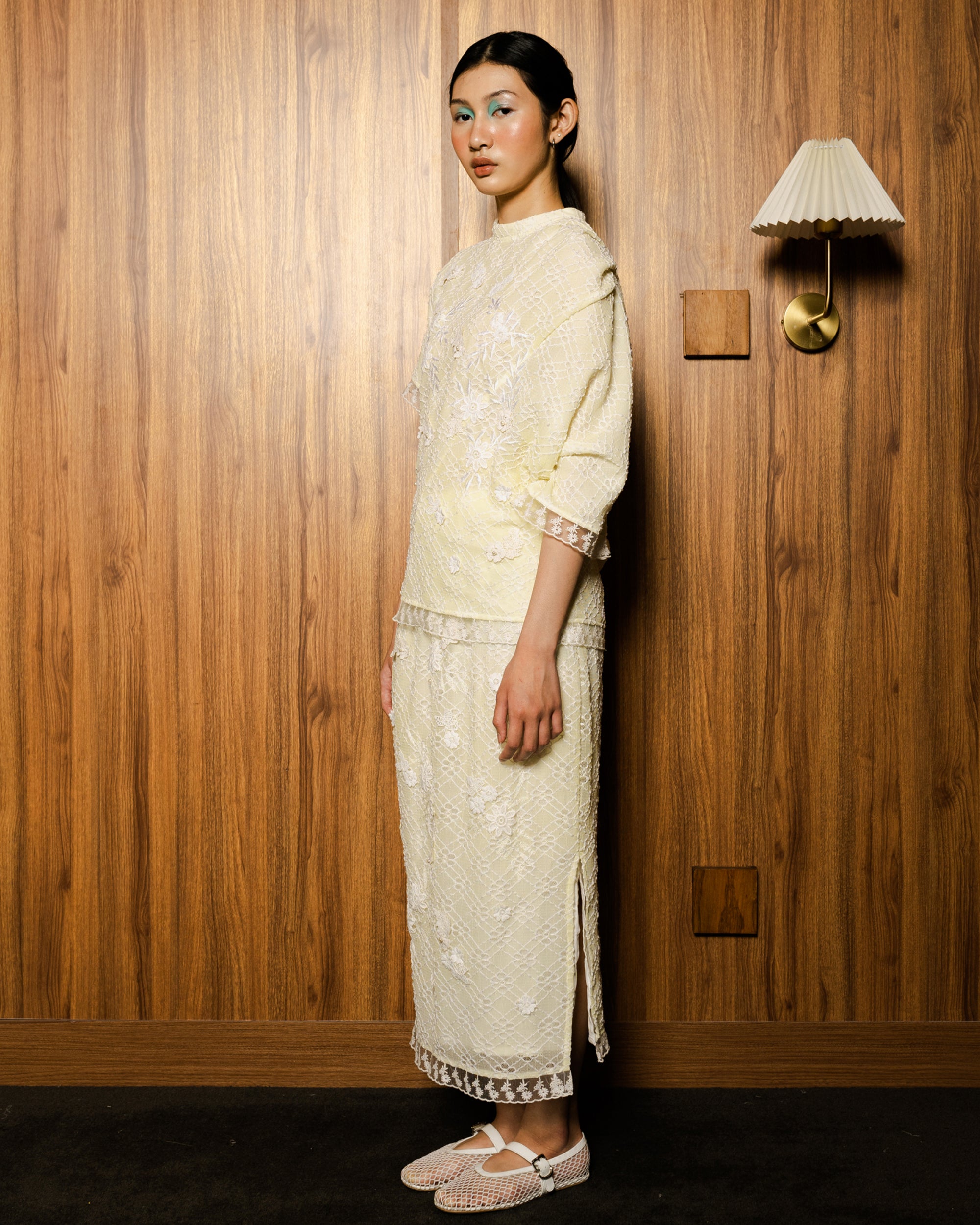 Image of Ava Blouse Yellow, an assymetric drape blouse made from embroidered lace.