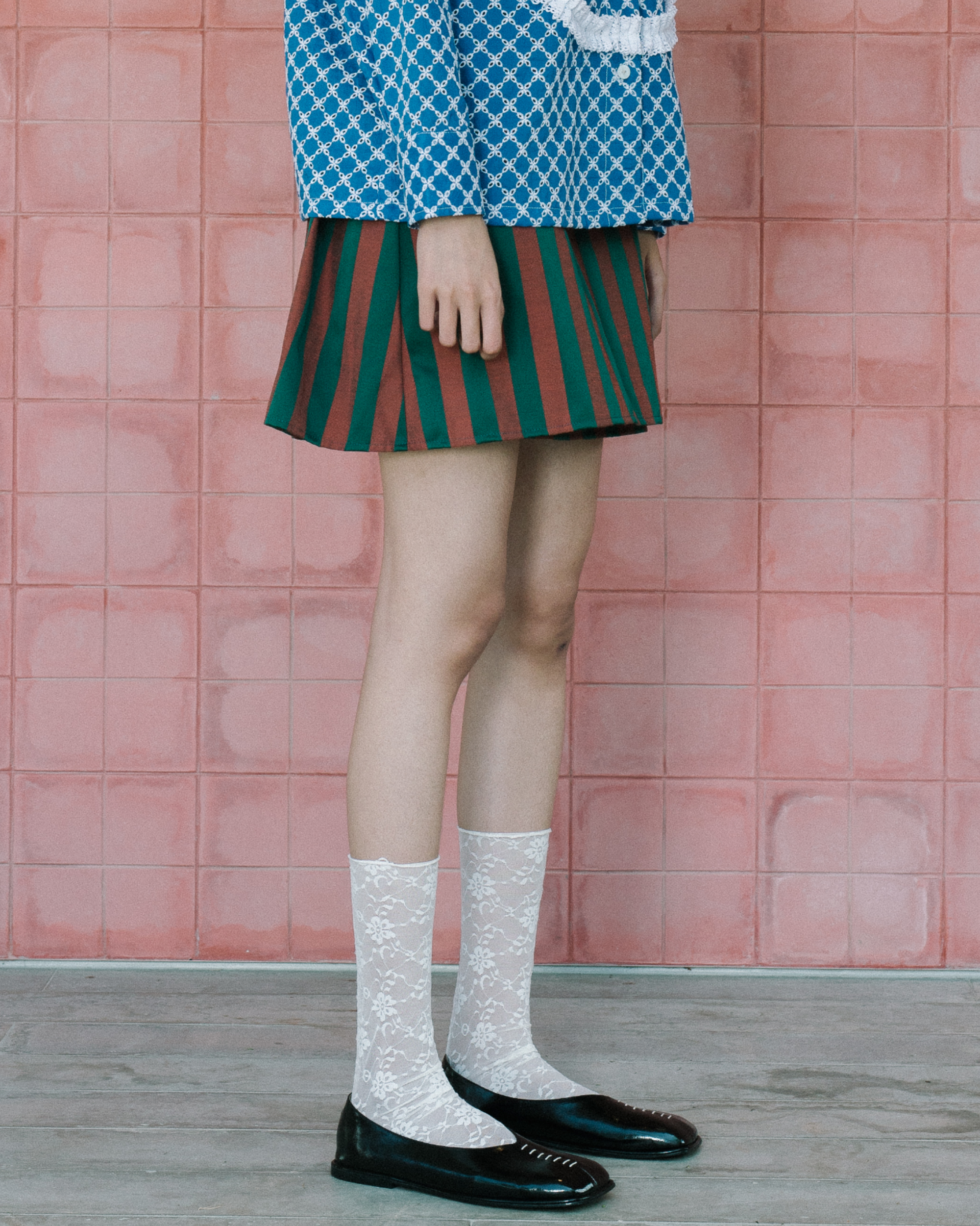 Image of Berthe Mini Wrap Skirt, a playful mini skirt with a flattering wrap design made from jacquard cotton.