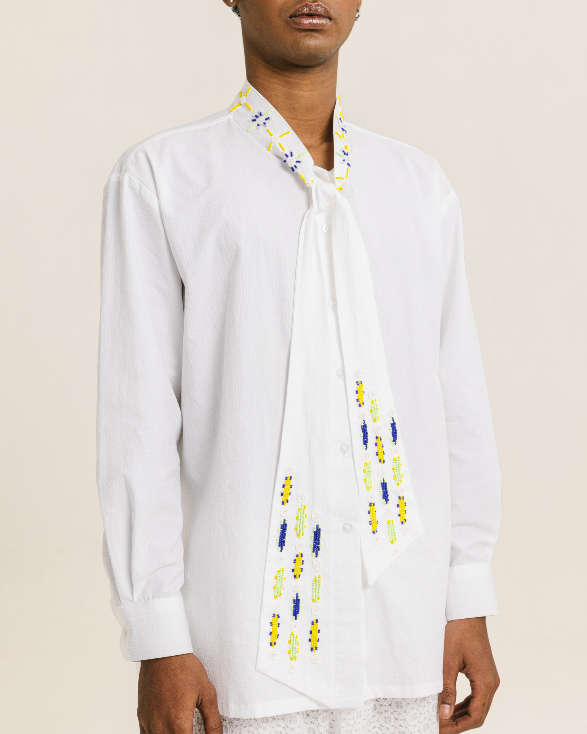 Image of Caspian Bow Shirt White, a shirt made from cotton with a hand-beaded collar-tie detail.