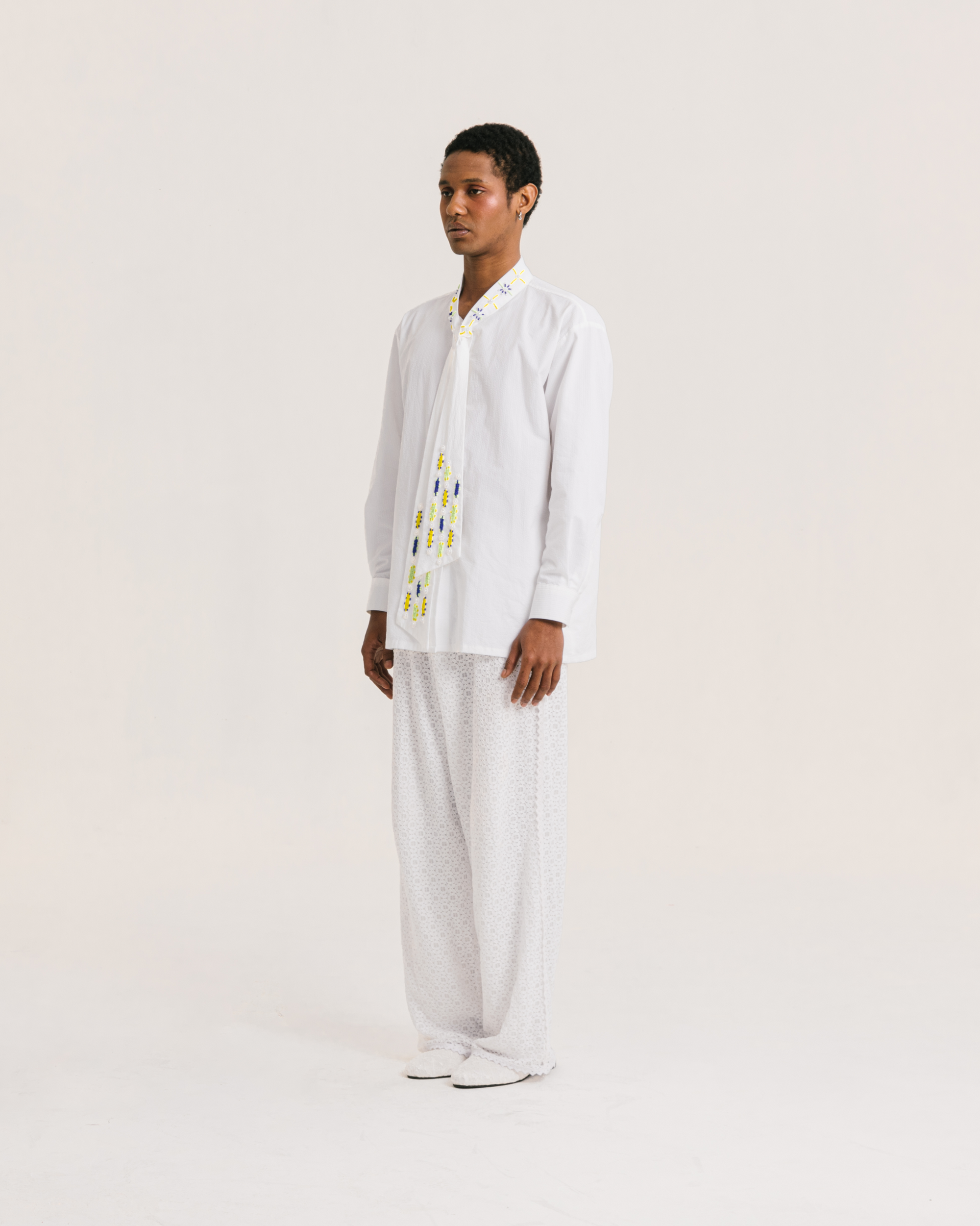 Image of Caspian Bow Shirt White, a shirt made from cotton with a hand-beaded collar-tie detail.