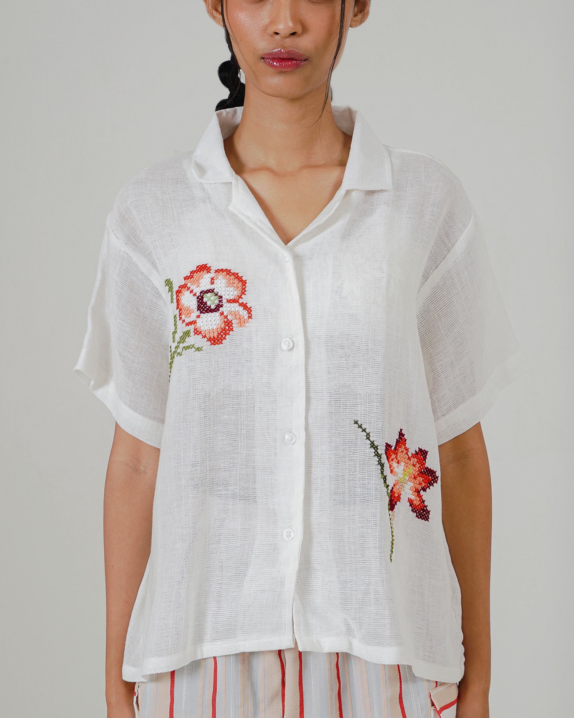 Image of Dhayu Cross Stitches Shirt, a linen shirt, hand-embroidered with flower-patterned cross-stitches.