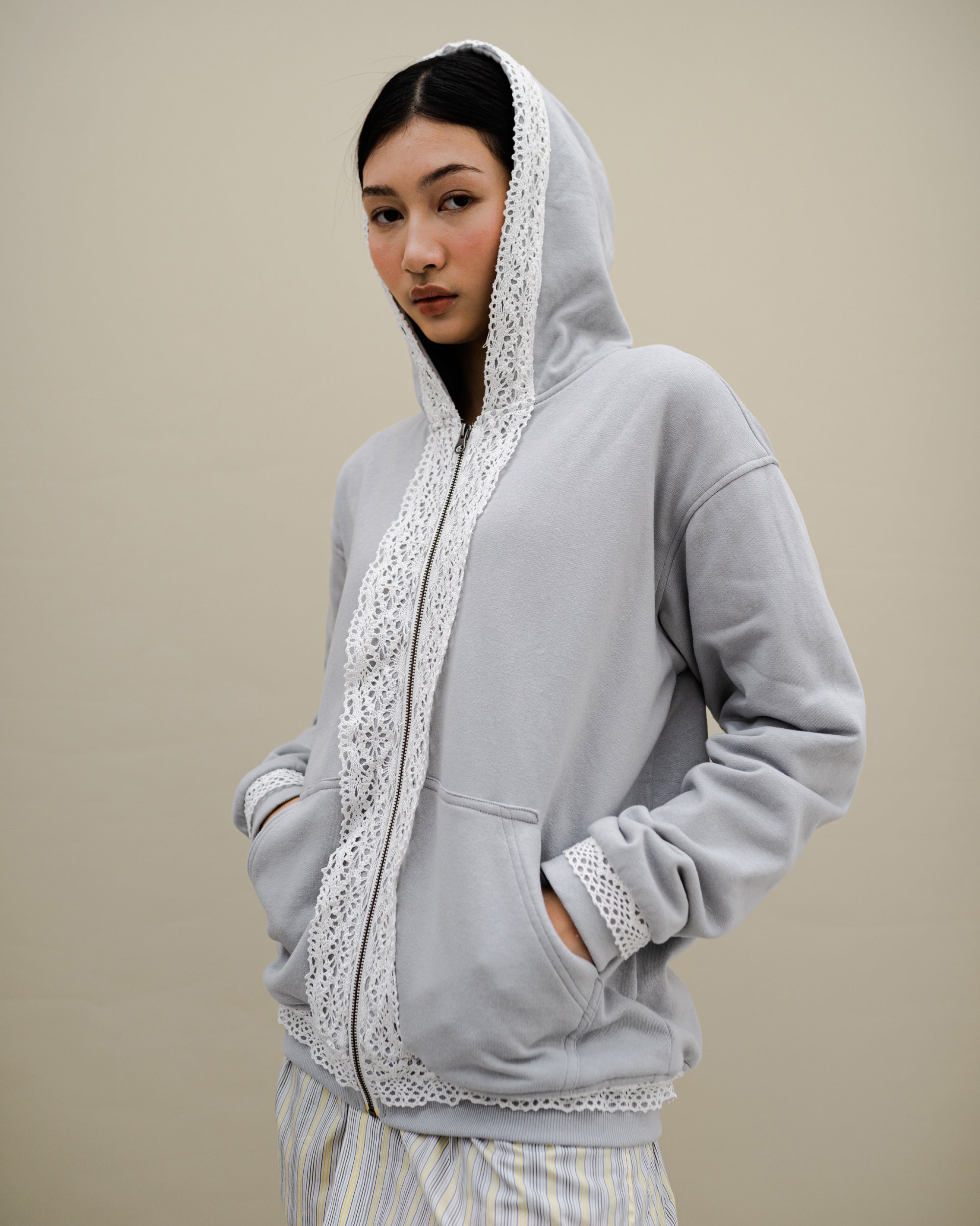 Image of Dune Lace Hoodie Grey, a hoodie jacket with lace detail on along the zipper.