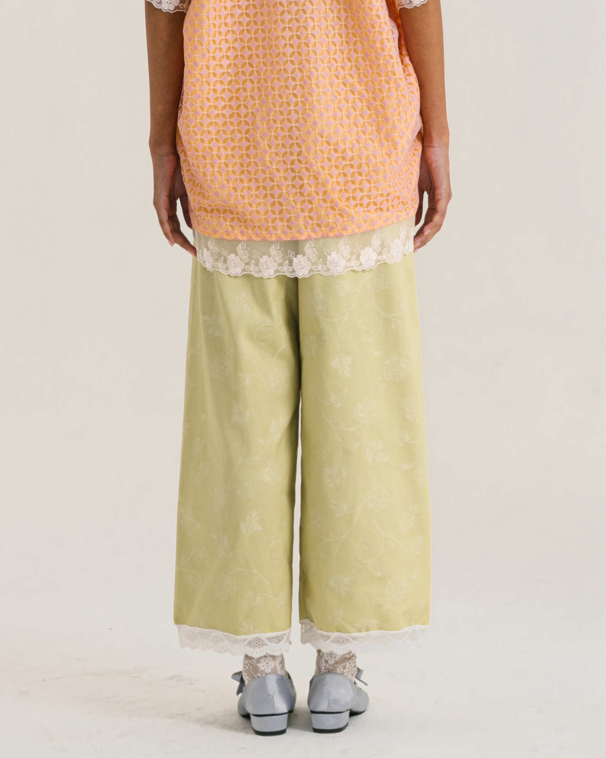 Image of Ebba Pants Lime, a straight-cut pants made from soft and breathable cotton with a subtle flower-patterned.