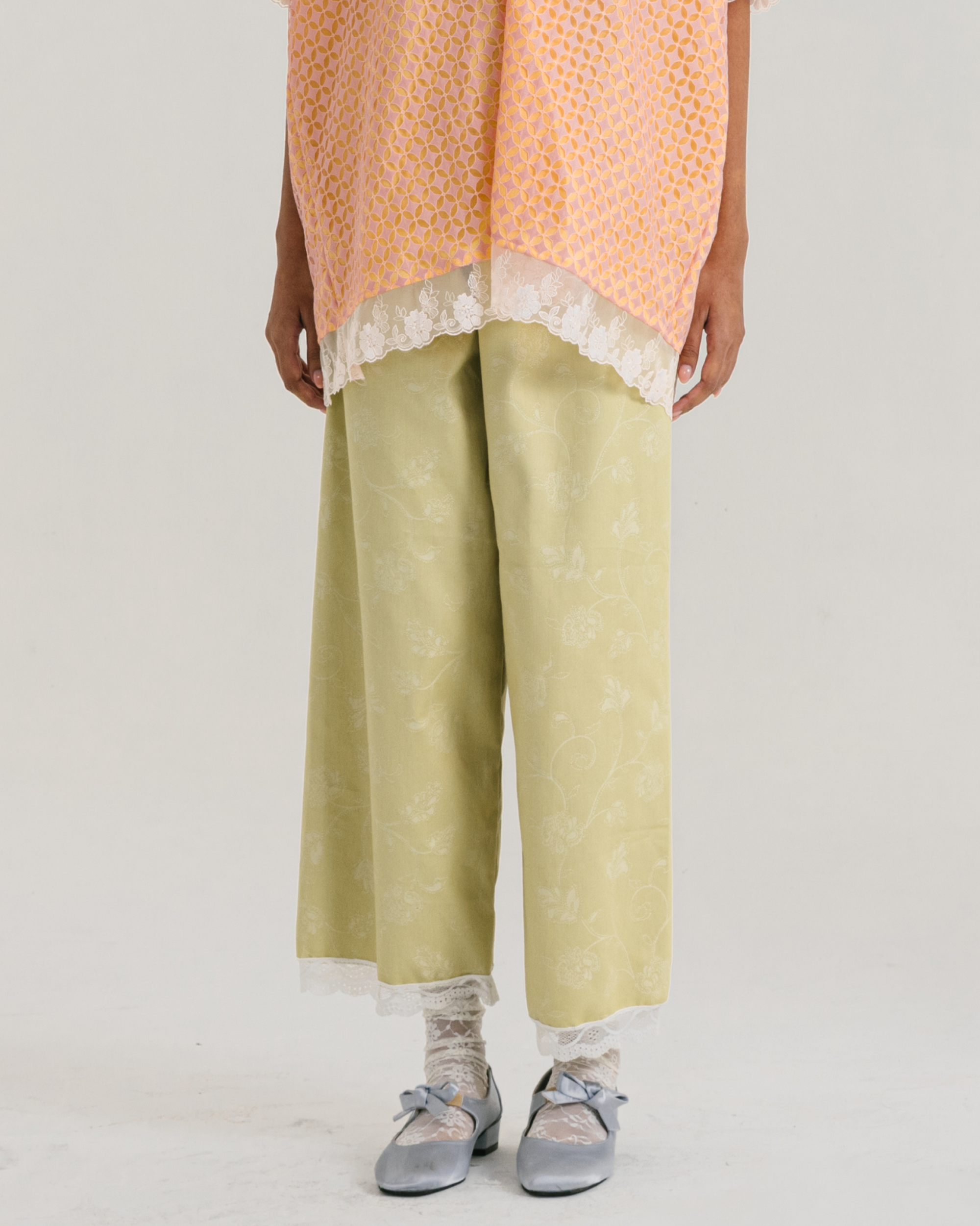 Image of Ebba Pants Lime, a straight-cut pants made from soft and breathable cotton with a subtle flower-patterned.