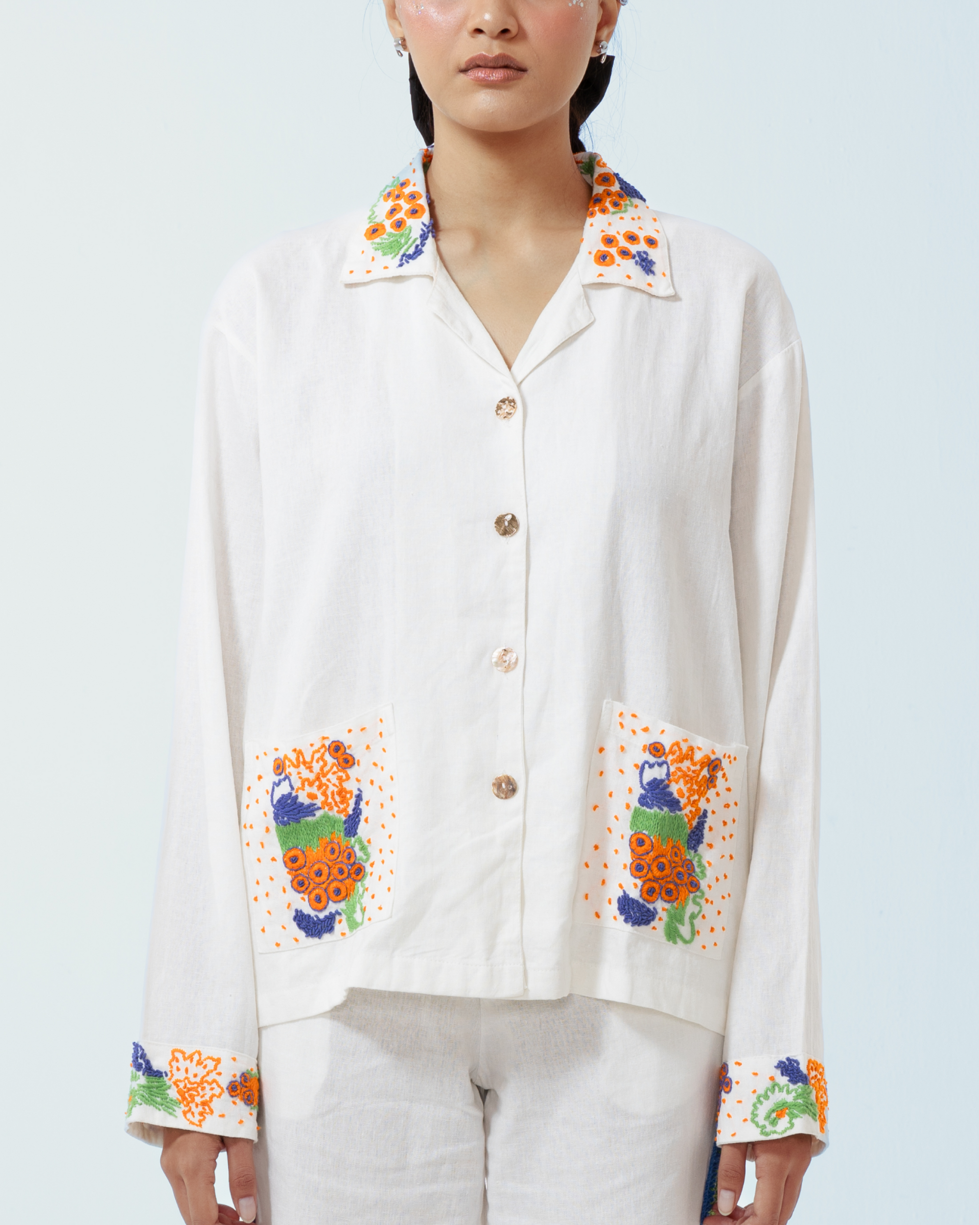 Image of Granada Jacket White, a shirt-jacket made from deadstock linen with a hand-embroidery detailing on the collar, pockets, and cuffs.