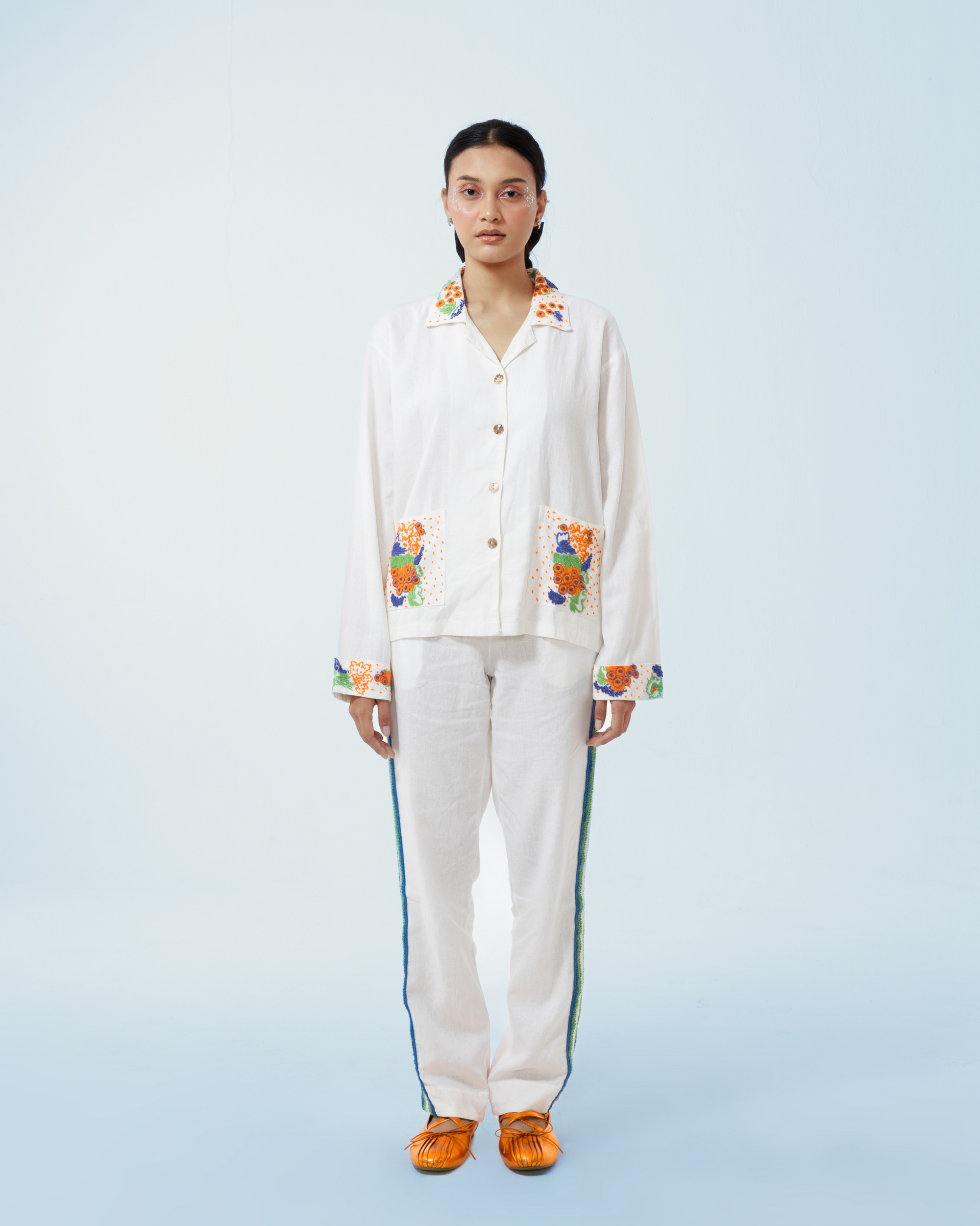 Image of Granada Jacket White, a shirt-jacket made from deadstock linen with a hand-embroidery detailing on the collar, pockets, and cuffs.