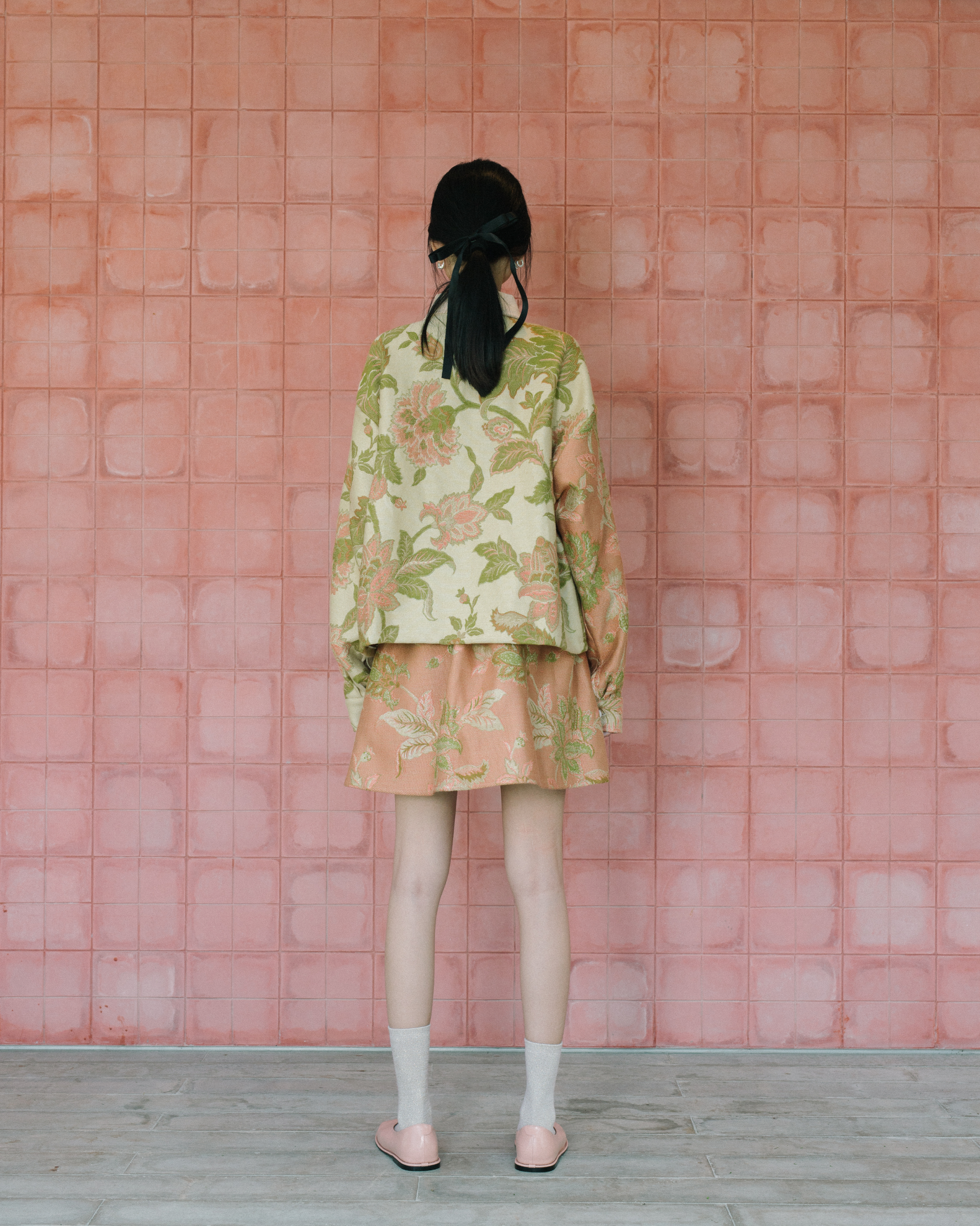 Image of Gretl Flower Jacket, a relaxed fit jacket made from jacquard fabric, adorned with unique white buttons. 