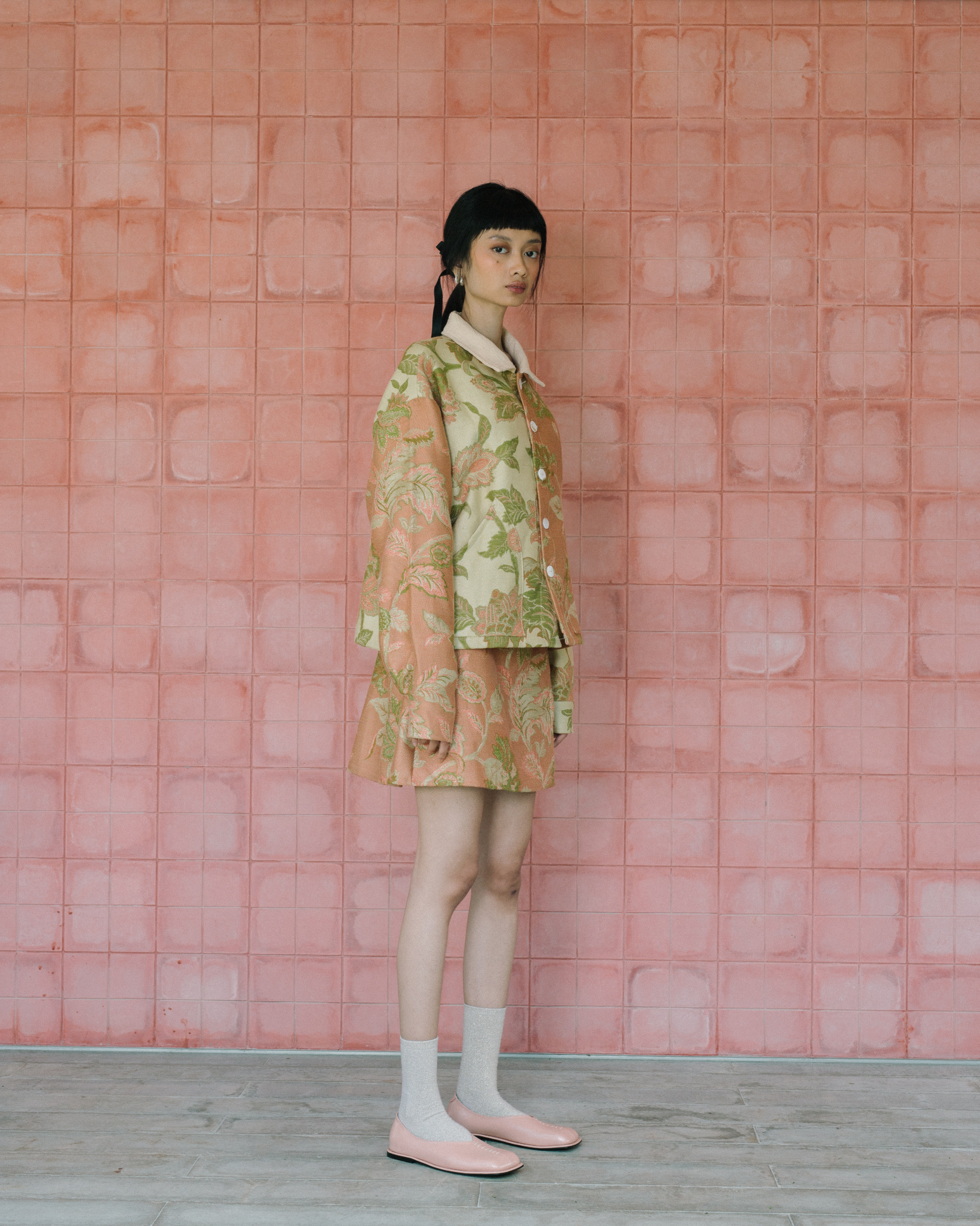 Image of Gretl Flower Jacket, a relaxed fit jacket made from jacquard fabric, adorned with unique white buttons. 