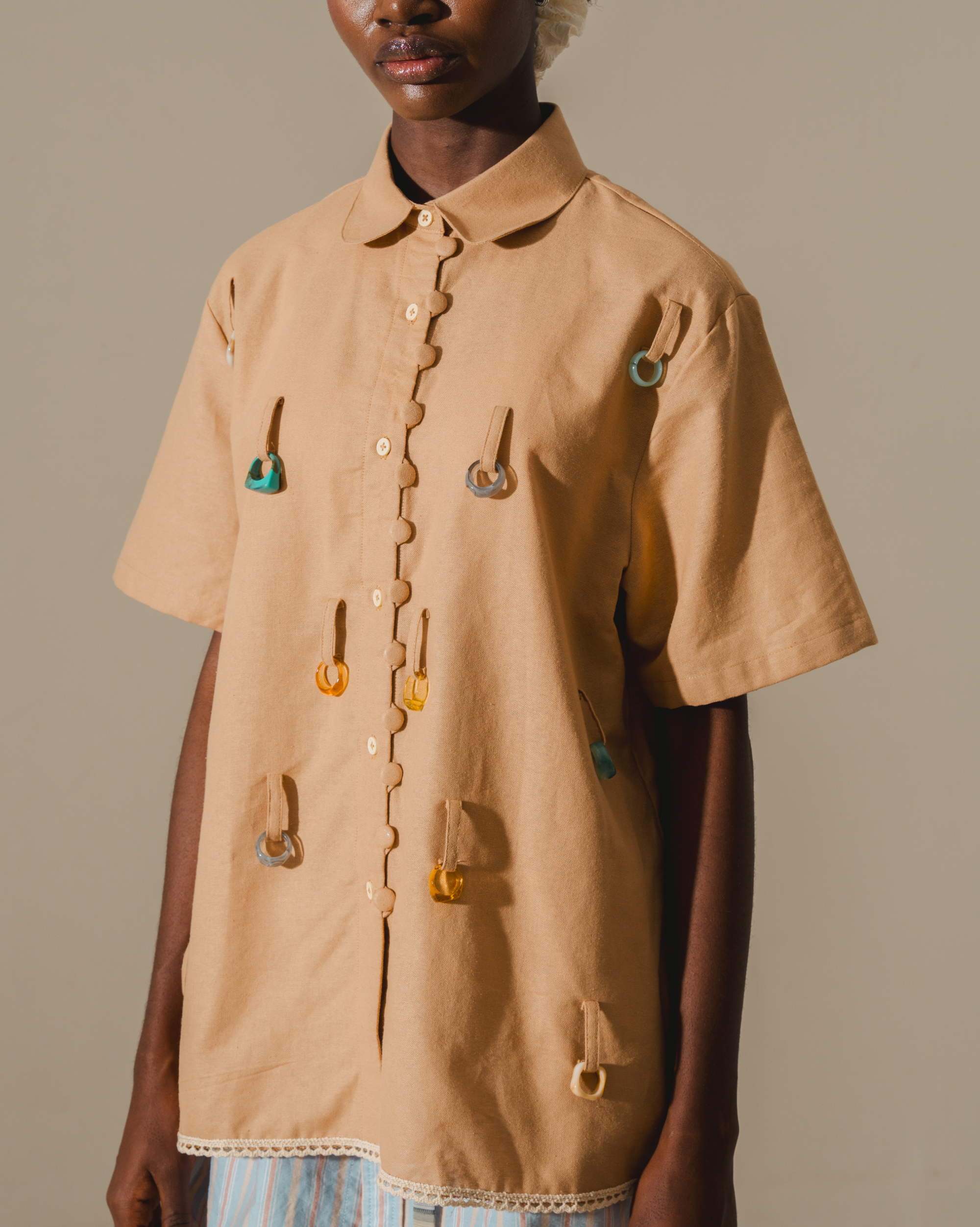 Image of Heim Ring Shirt, a shirt made from deadstock linen with jewel toy rings attached.