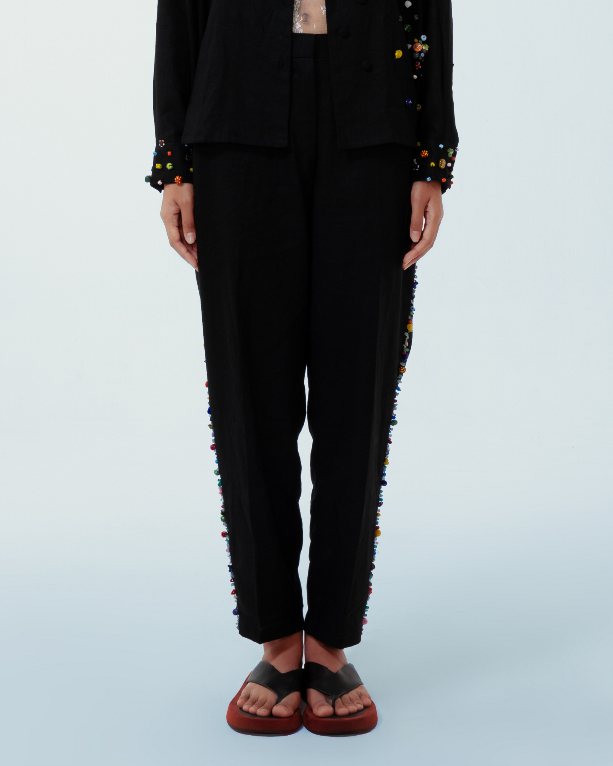 Image of Lola Pants Black, a pants made from deadstock linen with hand-sewn recycled beads on the side of the pants.