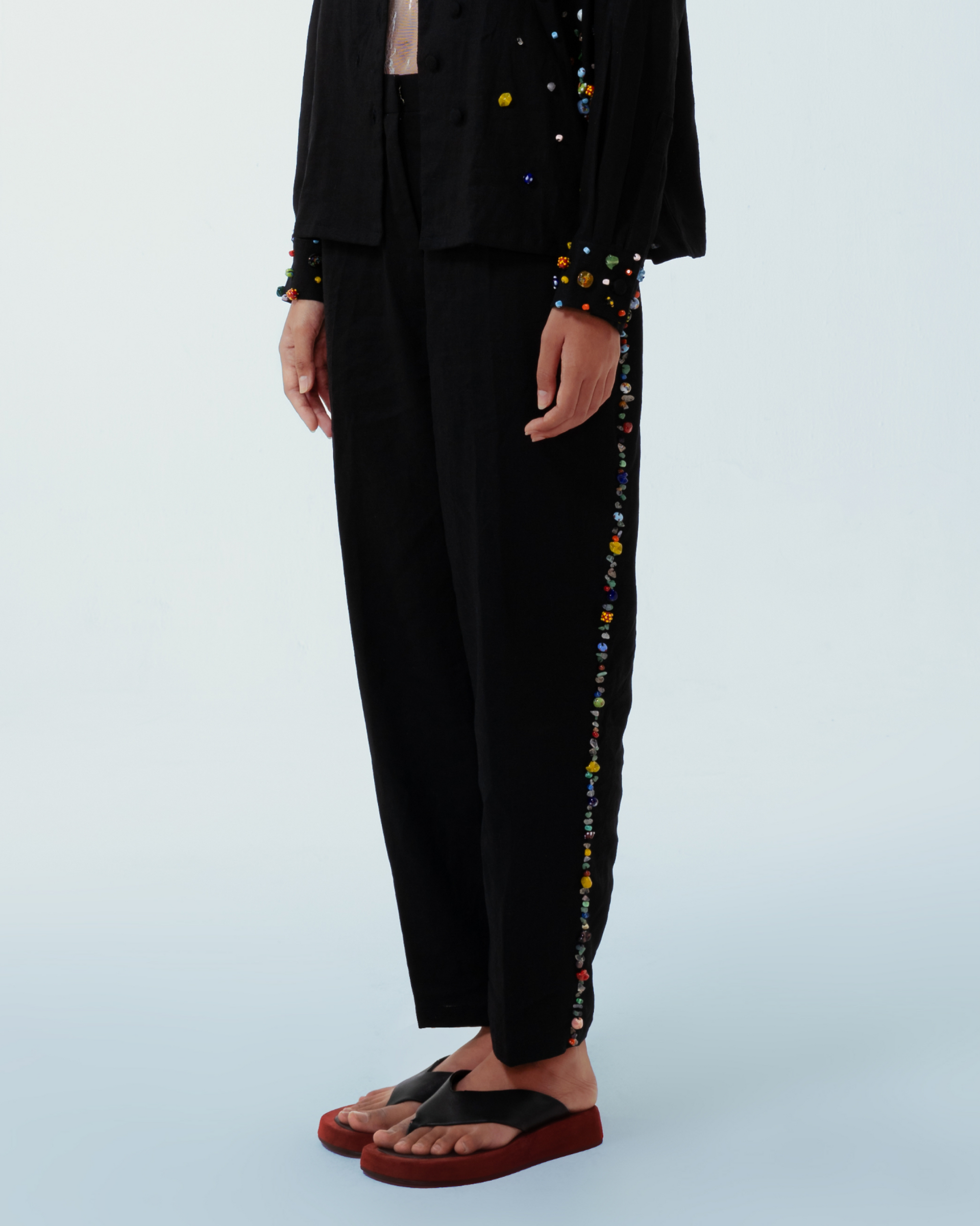 Image of Lola Pants Black, a pants made from deadstock linen with hand-sewn recycled beads on the side of the pants.