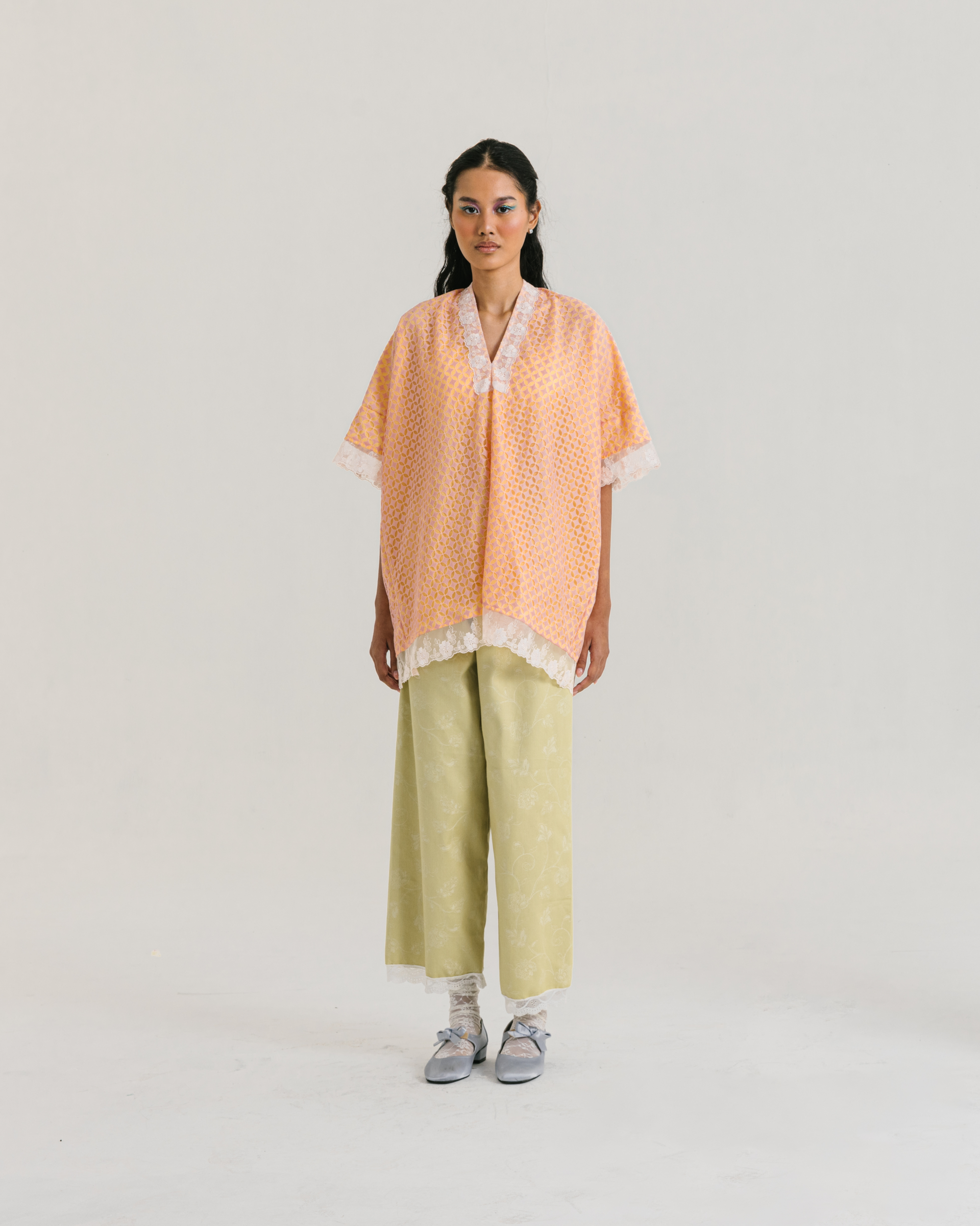 Image of Lucy Blouse Orange, a relaxed-fit blouse made from brocade and cotton with a modest v-neckline.