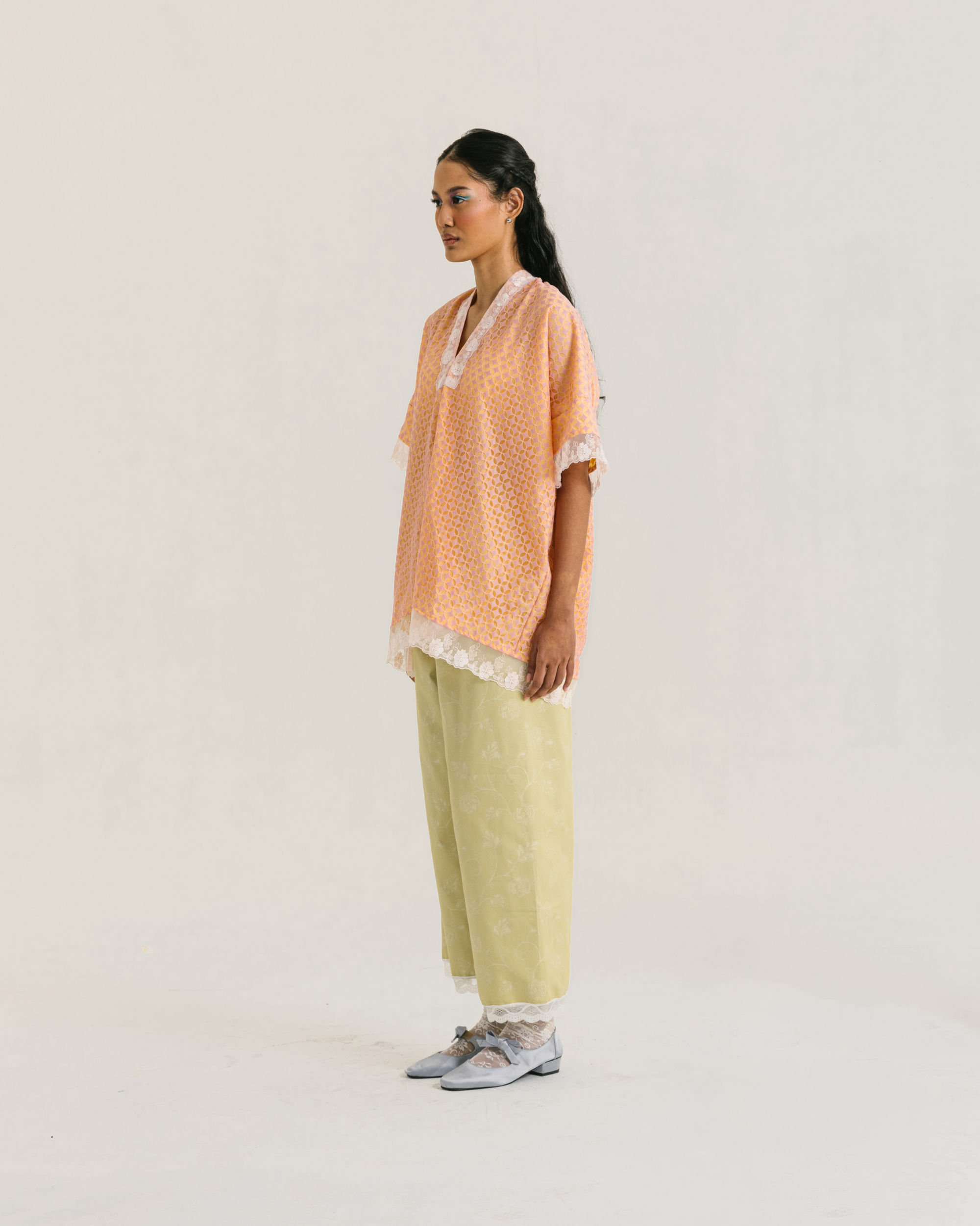 Image of Lucy Blouse Orange, a relaxed-fit blouse made from brocade and cotton with a modest v-neckline.