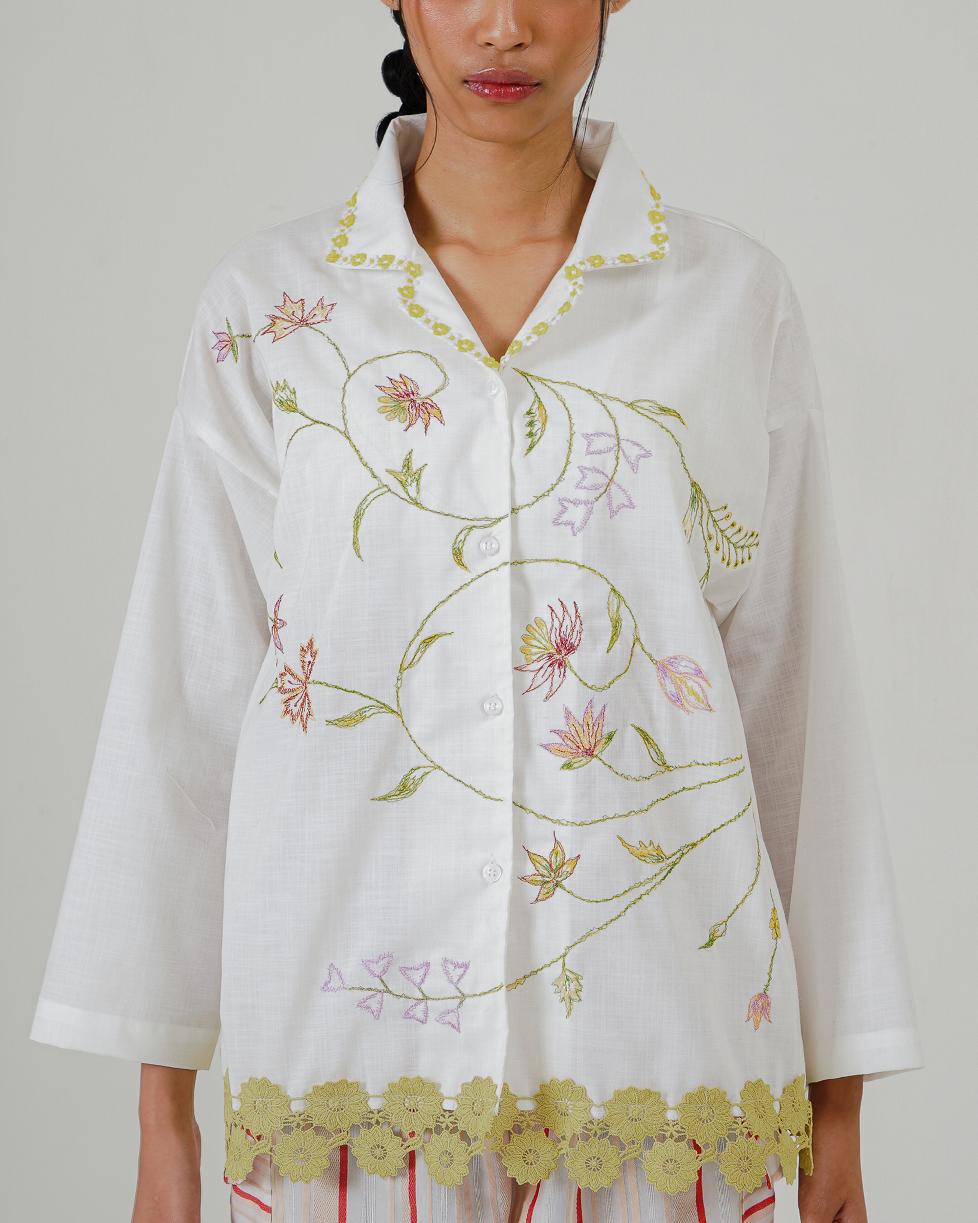 Image of Maira Embroidery Shirt Jacket, a long-sleeve top, adorned with flower embroidery and lace detailing at the hem.