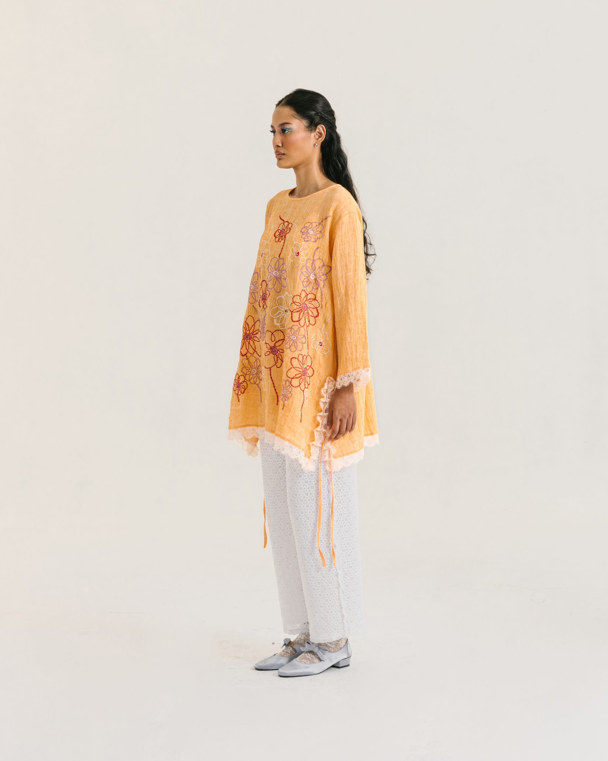 Image of Nora Embroidery Longsleeve Orange, a loose-fitting tunic made from cotton crepe, embroidered with chic floral design and adorned with delicate lace trims.