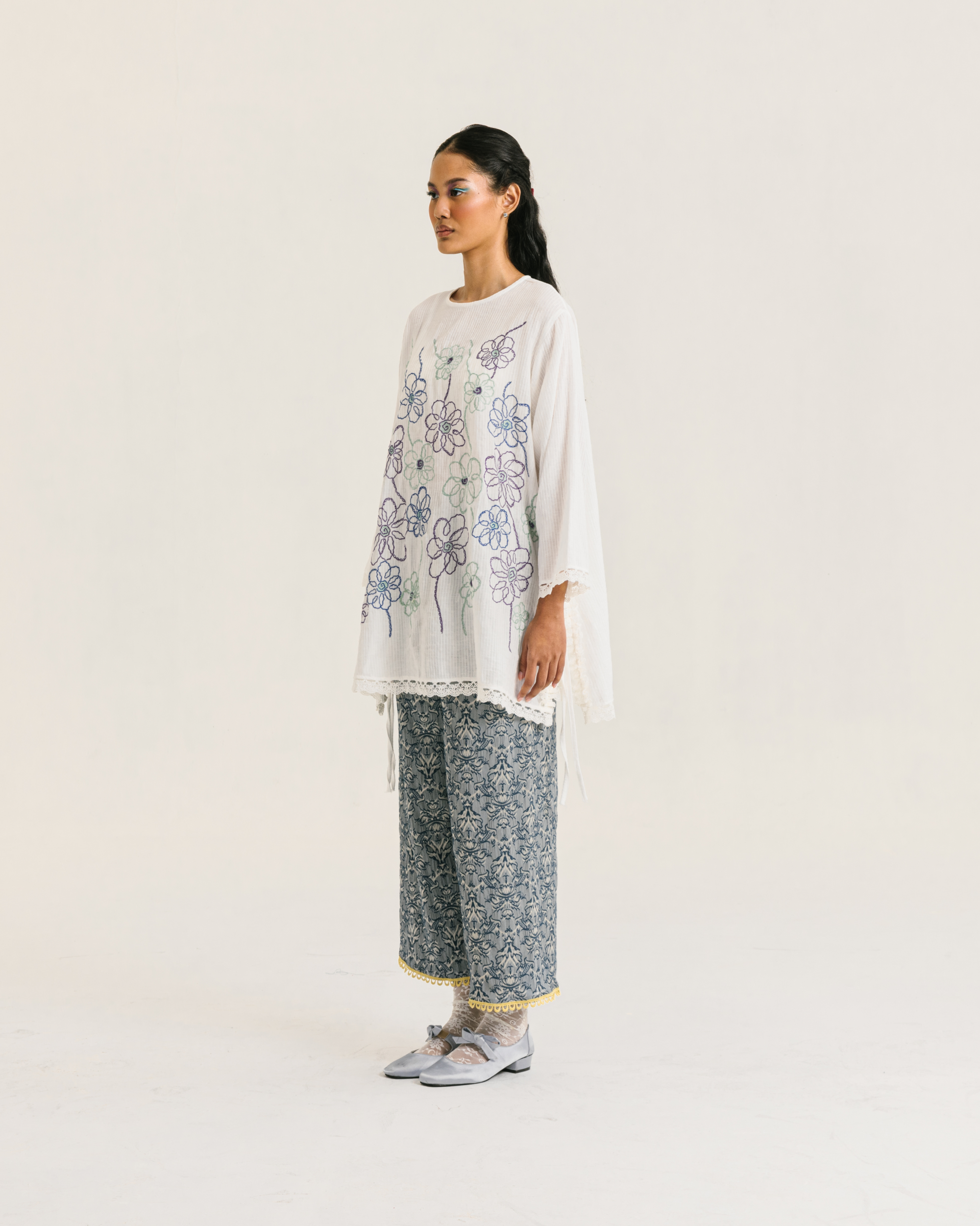 Image of Nora Embroidery Longsleeve White, a loose-fitting tunic made from cotton crepe, embroidered with chic floral design and adorned with delicate lace trims.