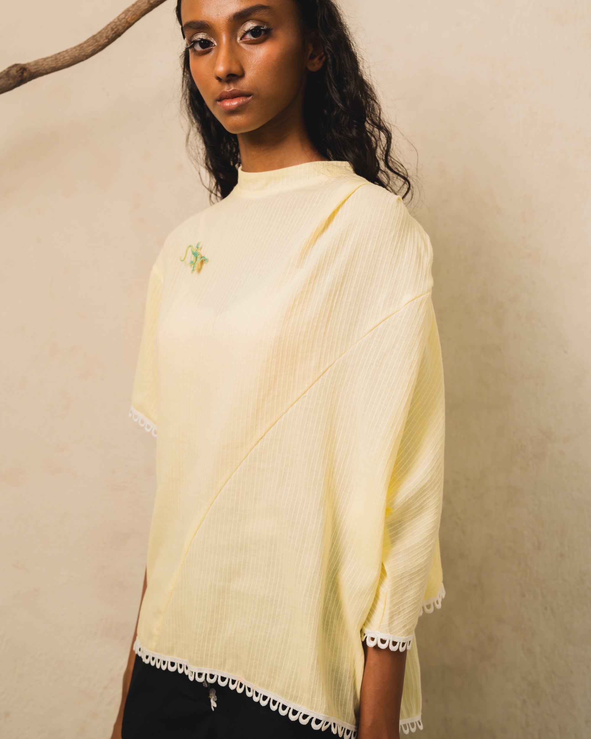 Image of Pierre Blouse Yellow, an asymmetric drape blouse made from cotton-poly.