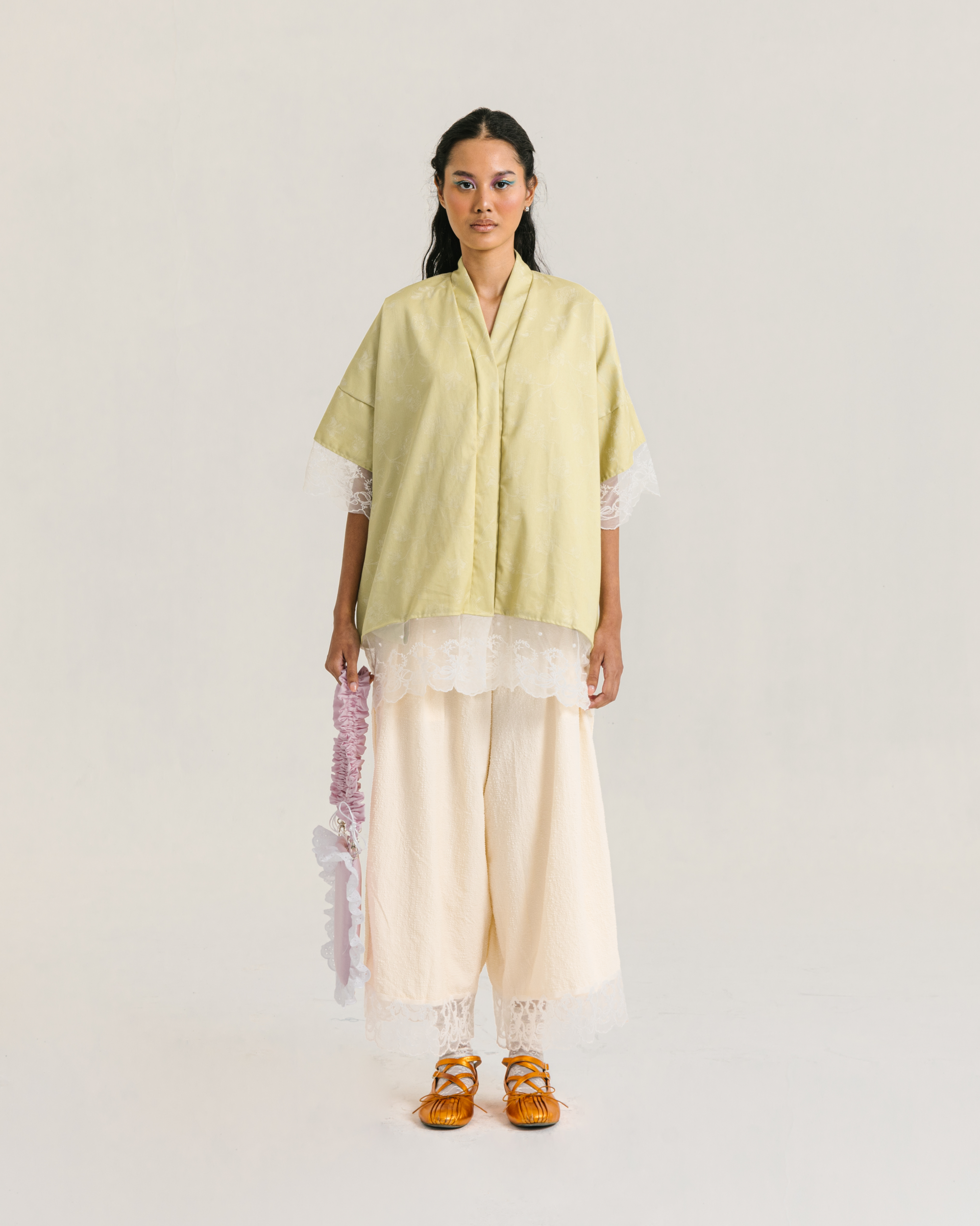 Image of Rayne Blouse Lime, a loose-fitting blouse made from cotton with a modest v-neckline.