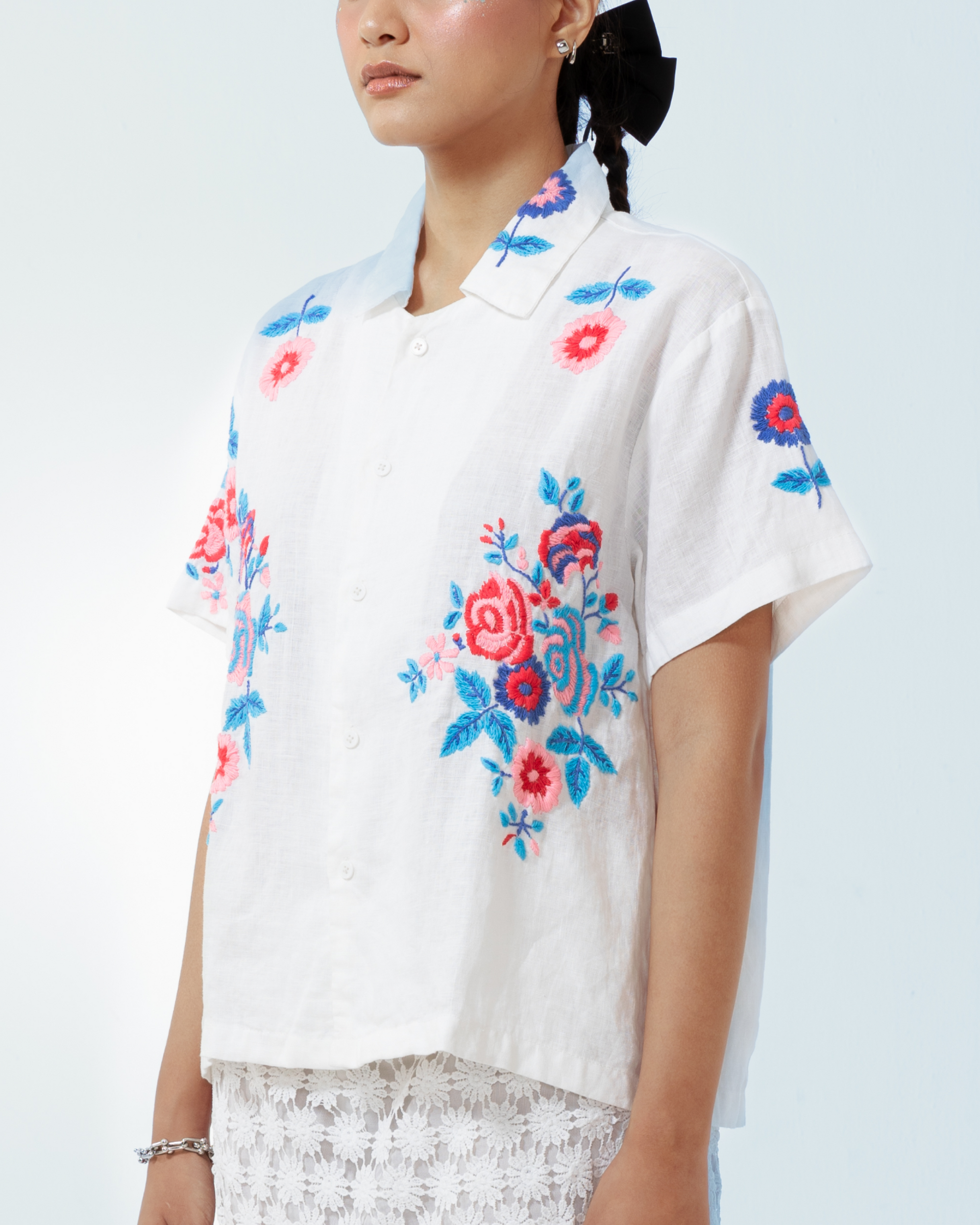 Image of Rosalia Shirt, a basic white linen shirt that is enhanced with floral hand-embroidery details thoughout.