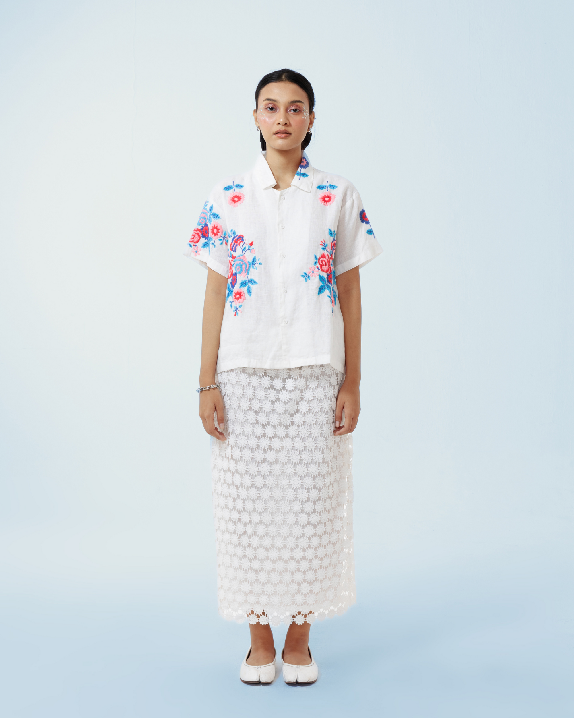 Image of Rosalia Shirt, a basic white linen shirt that is enhanced with floral hand-embroidery details thoughout.