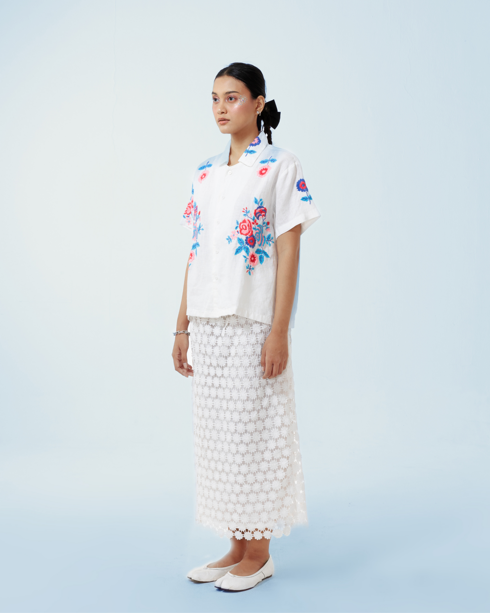 Image of Rosalia Shirt, a basic white linen shirt that is enhanced with floral hand-embroidery details thoughout.