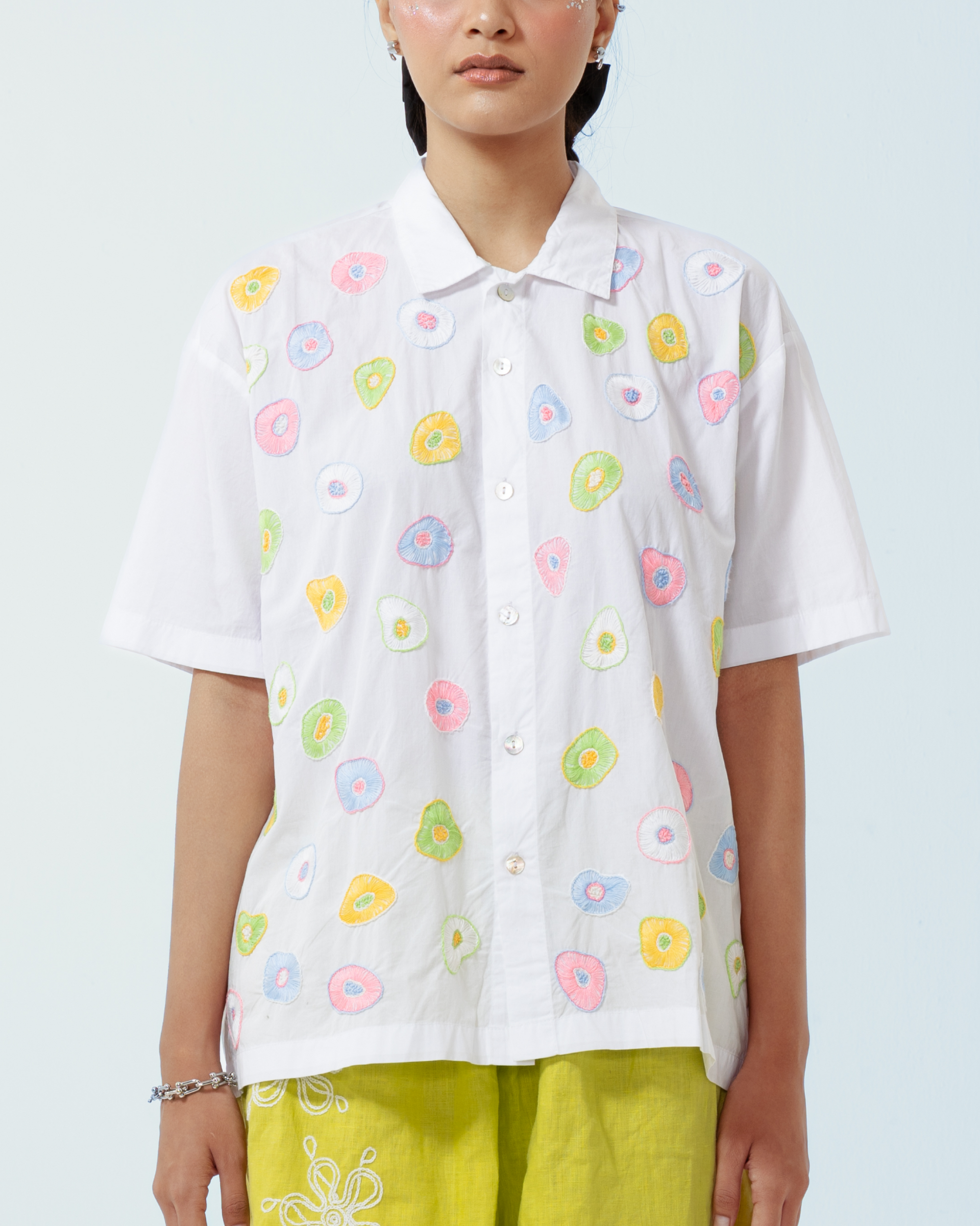 Image of Seta Embroidery Shirt Pastel, a basic white cotton shirt that is enhanced with artistic hand-embroidery details thoughout