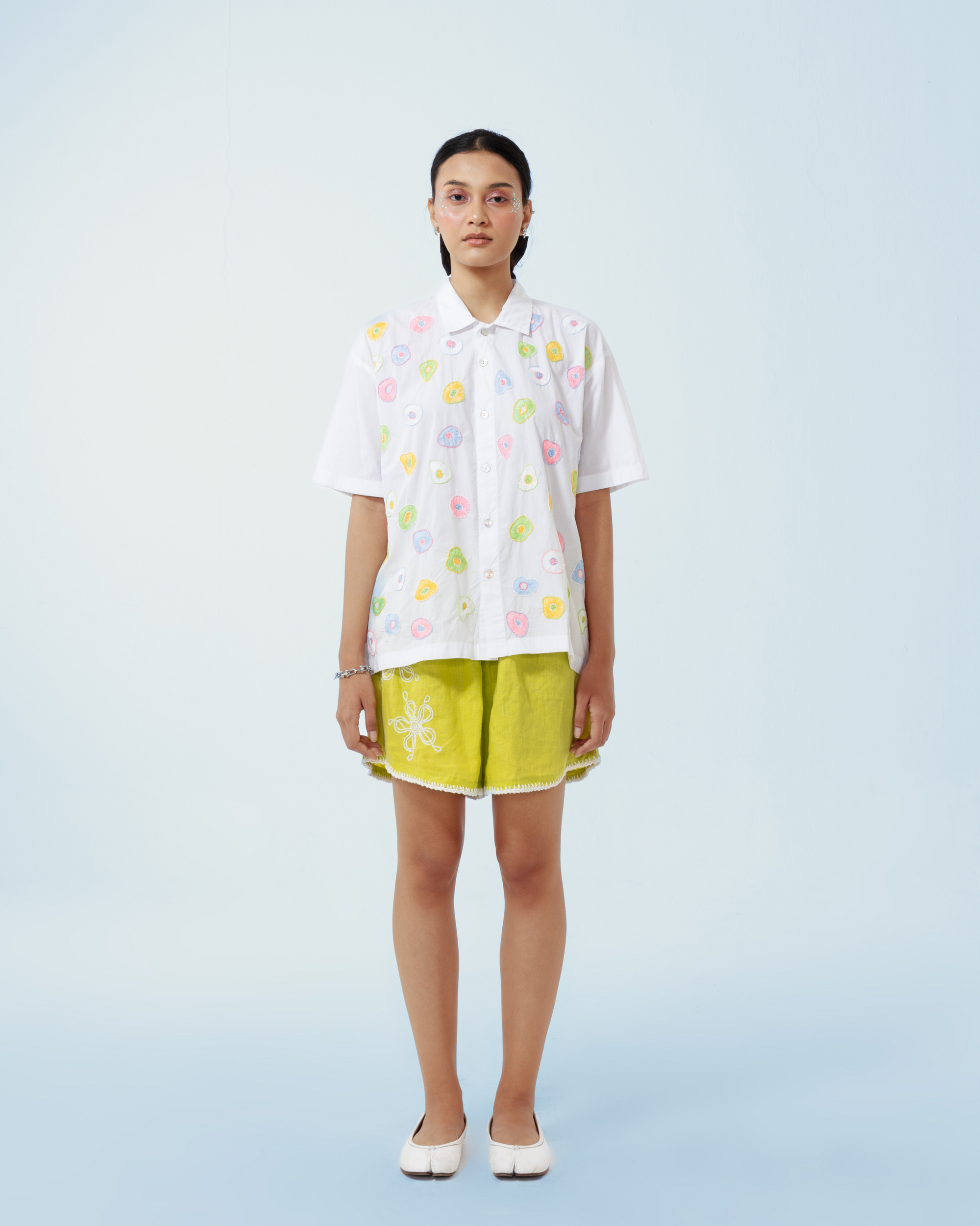 Image of Seta Embroidery Shirt Pastel, a basic white cotton shirt that is enhanced with artistic hand-embroidery details thoughout