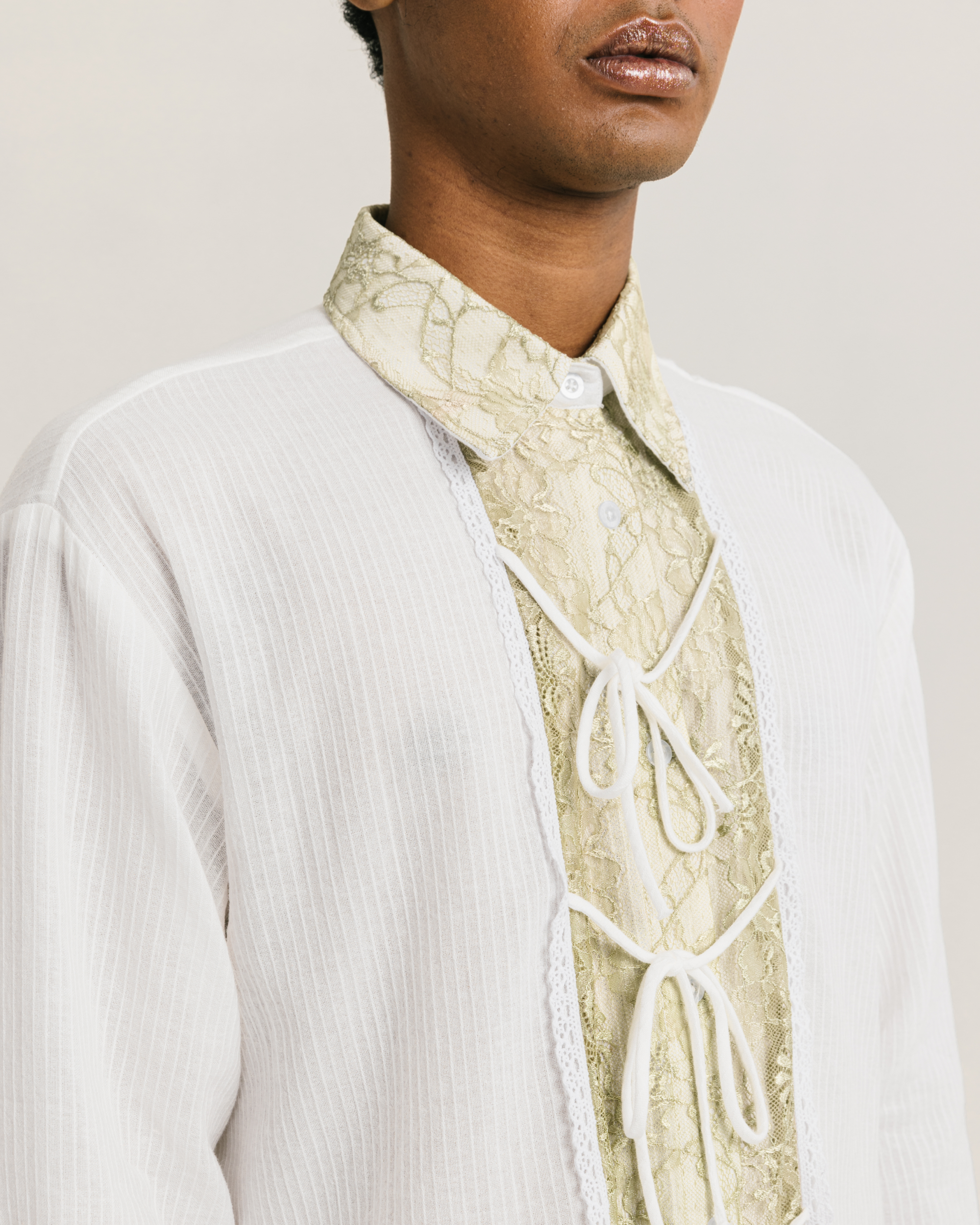 Image of Simone Longsleeve Shirt White, a longsleeve unisex shirt made from cotton-poly with an added lace and tie details on the front.