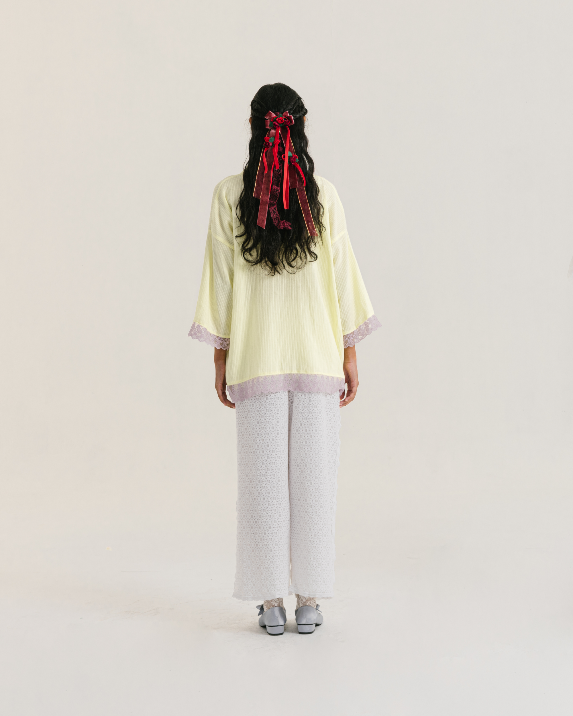 Image of Thea Longsleeve Yellow, a blouse made from cotton with ribbon-like lace on the front.