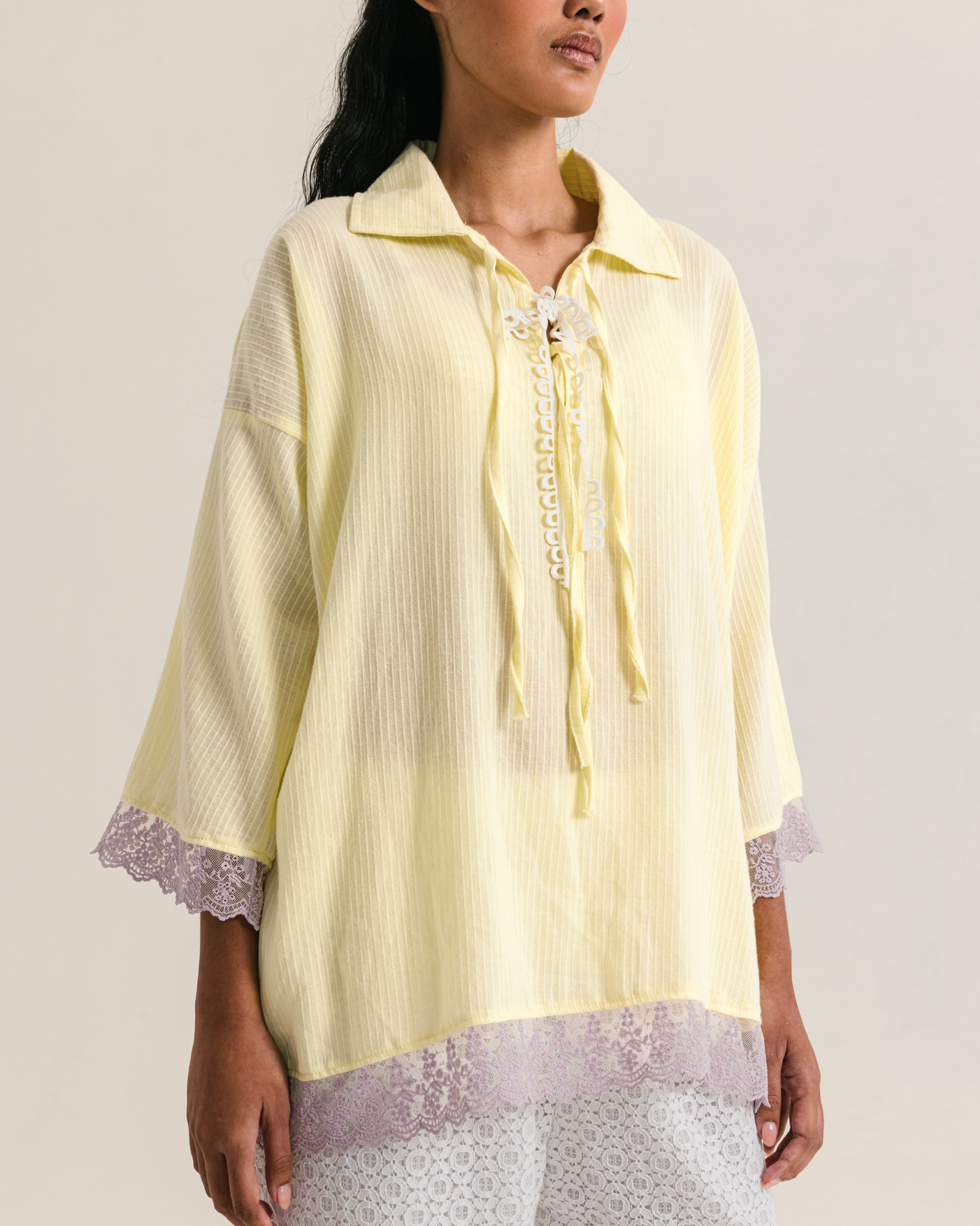 Image of Thea Longsleeve Yellow, a blouse made from cotton with ribbon-like lace on the front.