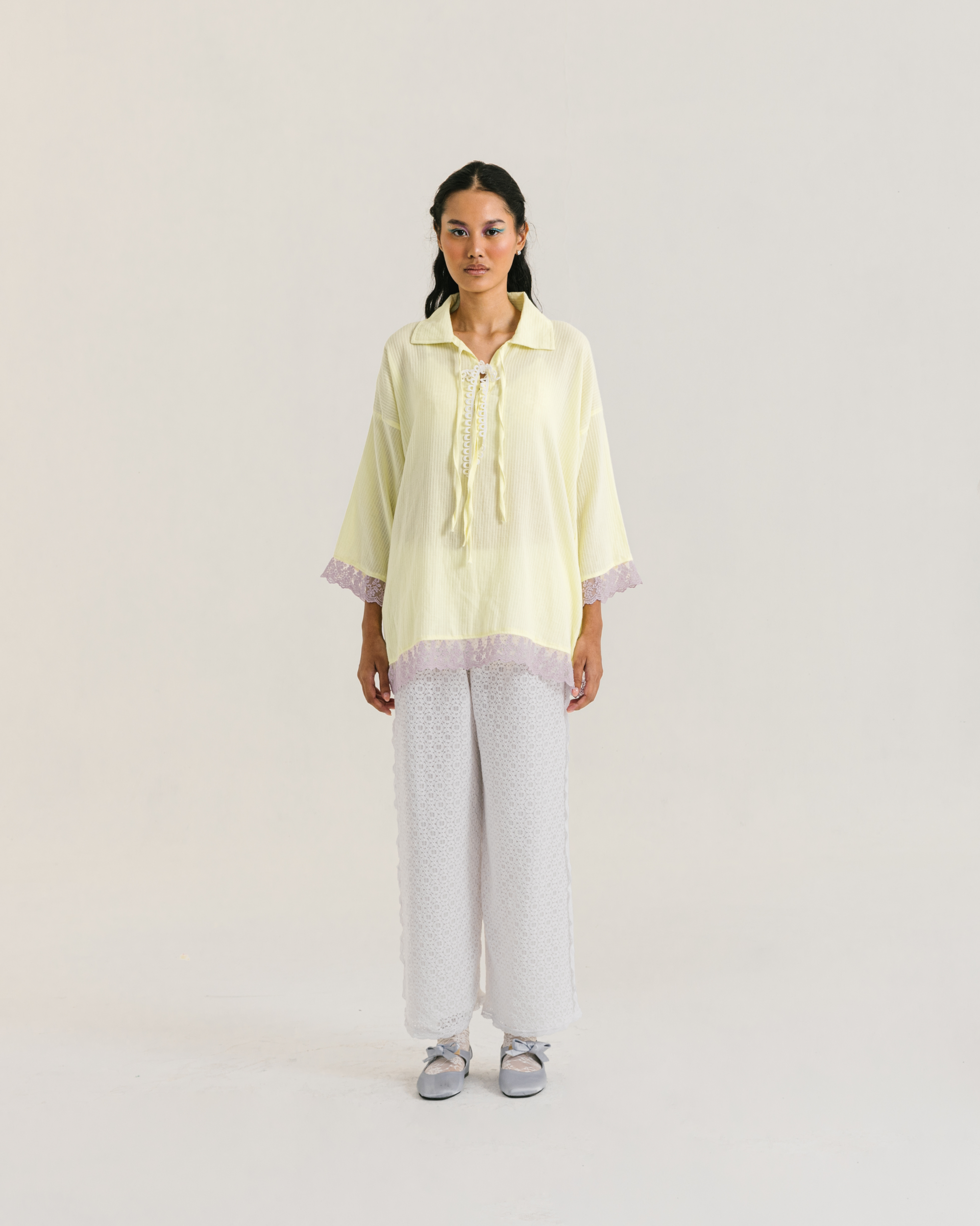 Image of Thea Longsleeve Yellow, a blouse made from cotton with ribbon-like lace on the front.