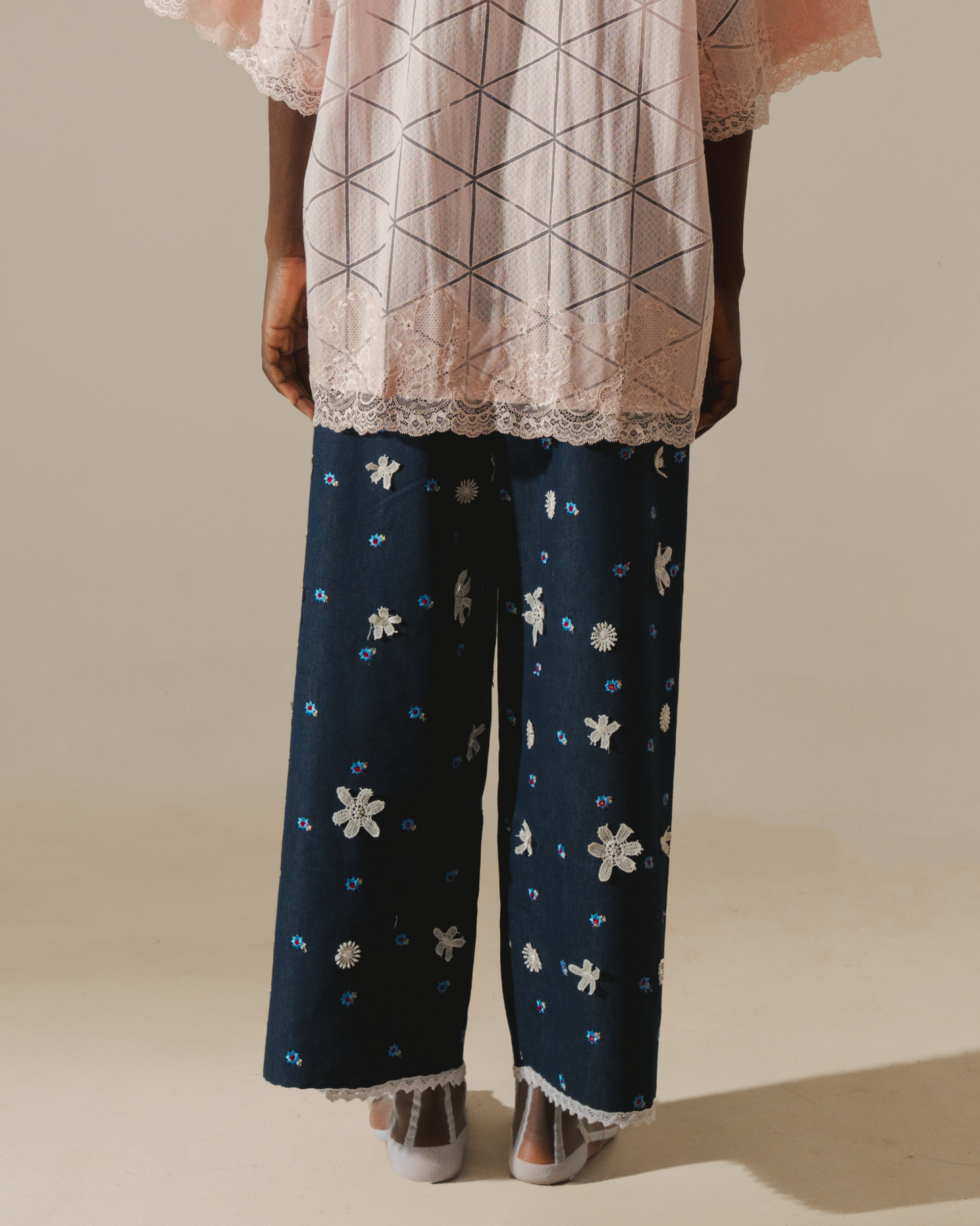 Image of Tiana Embroidery Pants, a relaxed wide-leg pants that are made from deadstock jacquard cotton, hand-embroidered with lace.