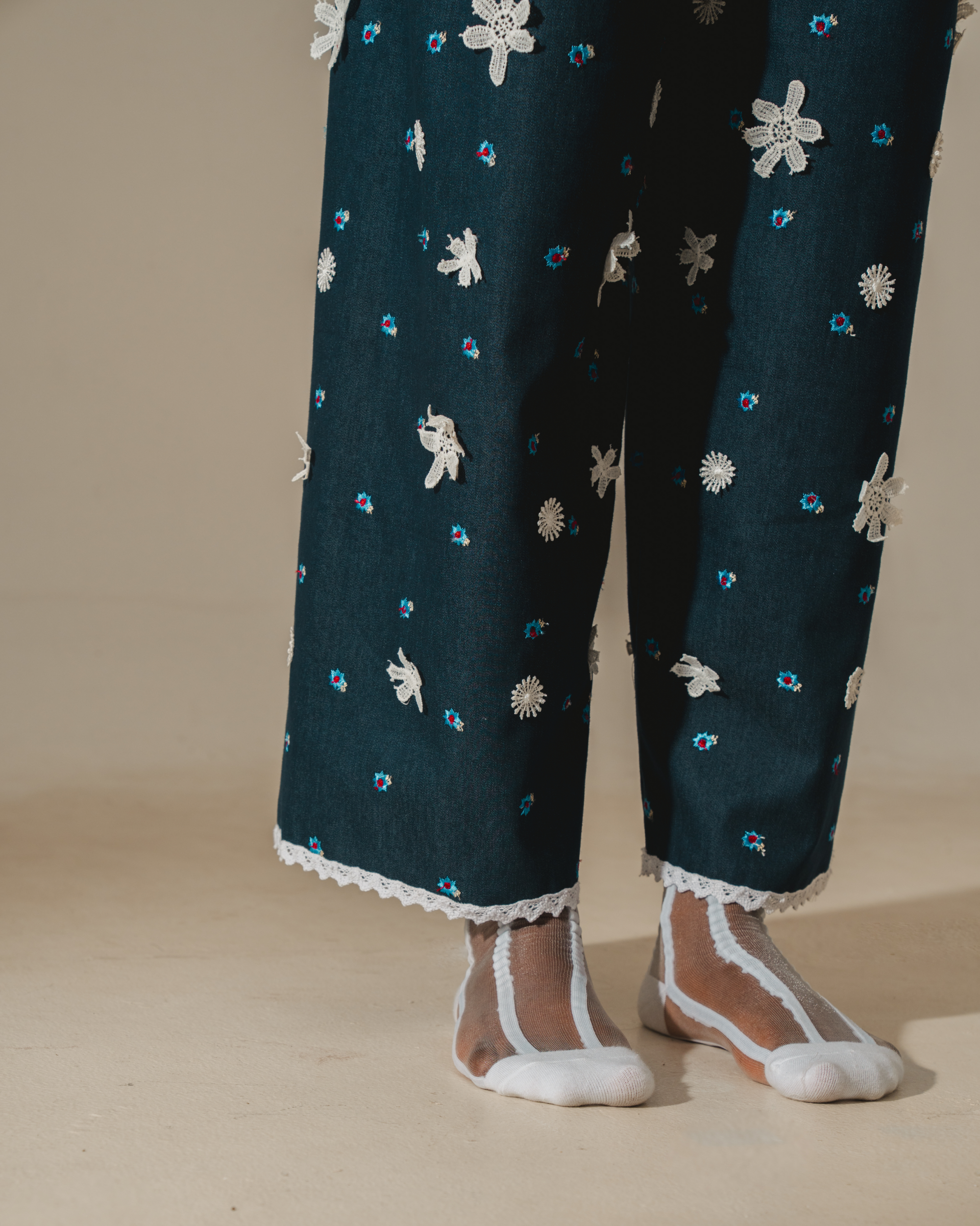 Image of Tiana Embroidery Pants, a relaxed wide-leg pants that are made from deadstock jacquard cotton, hand-embroidered with lace.