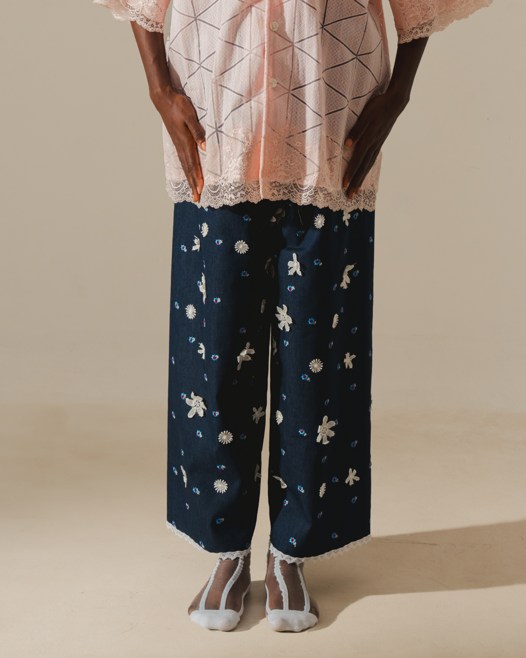 Image of Tiana Embroidery Pants, a relaxed wide-leg pants that are made from deadstock jacquard cotton, hand-embroidered with lace.