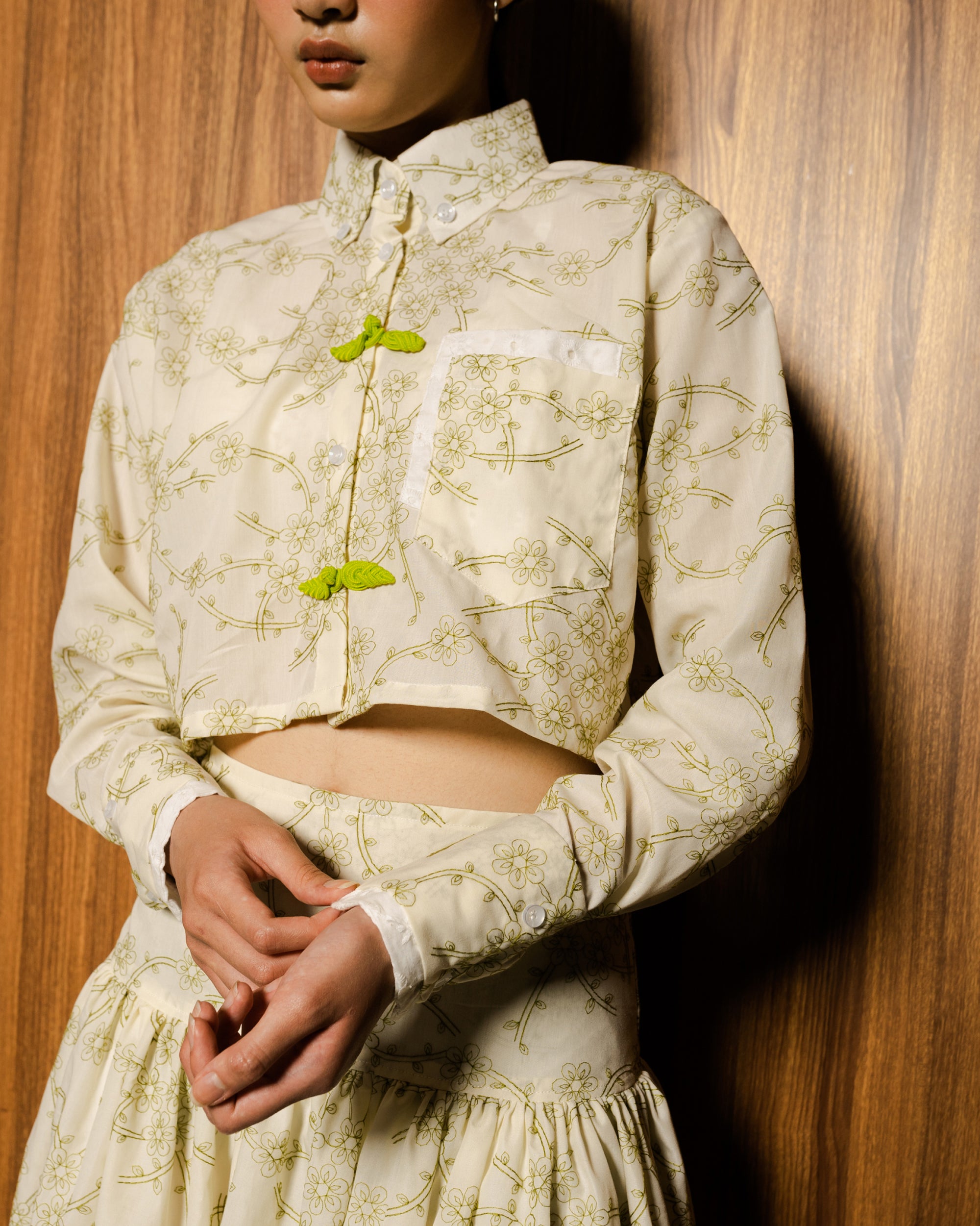 Image of Tianra Cropped Shirt Green, a cropped shirt with high neckline.