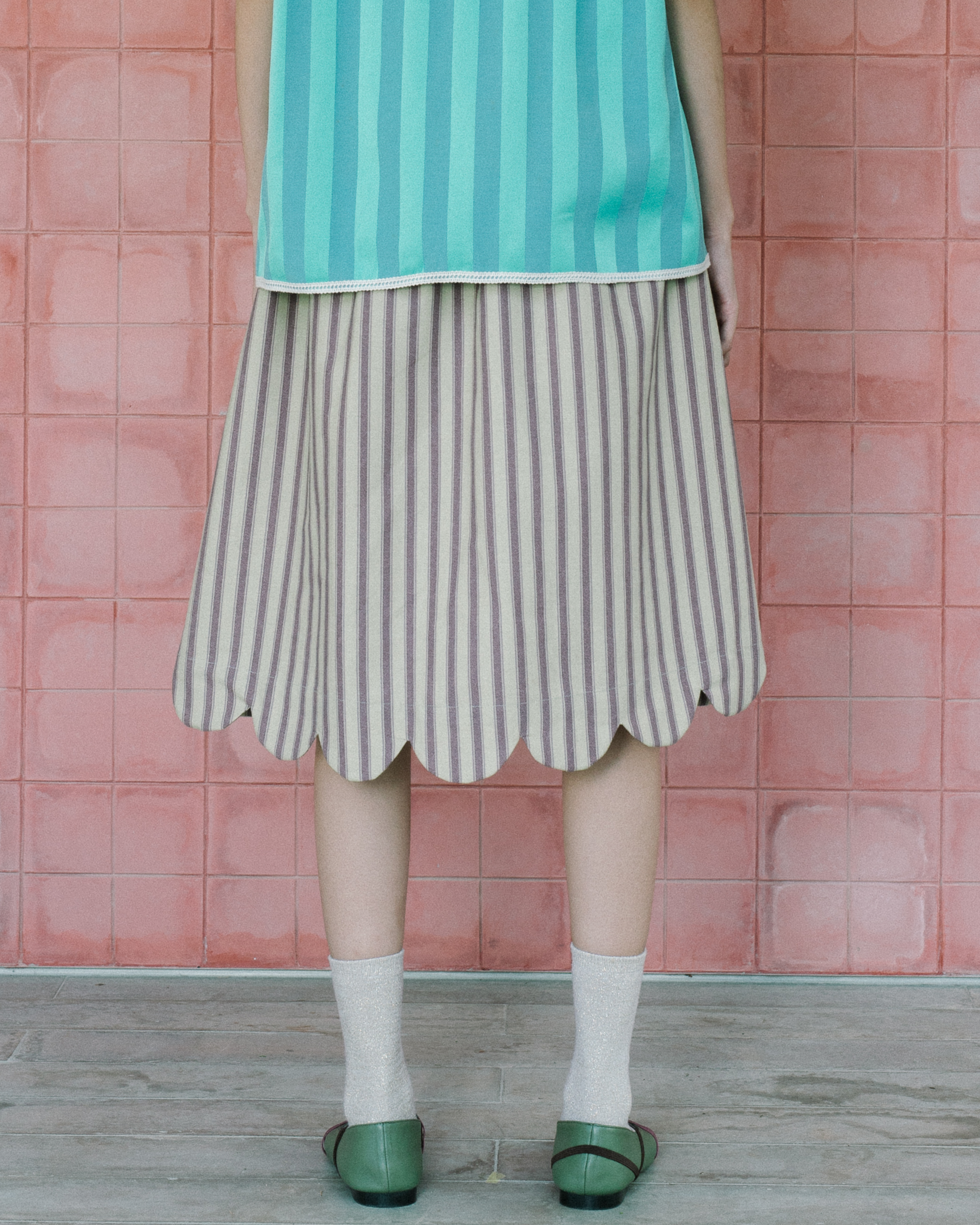 Image of Trap Scallop Skirt, a midi length skirt made from cotton combining a distinc scallop hem as a touch of whimsy and feminity. 