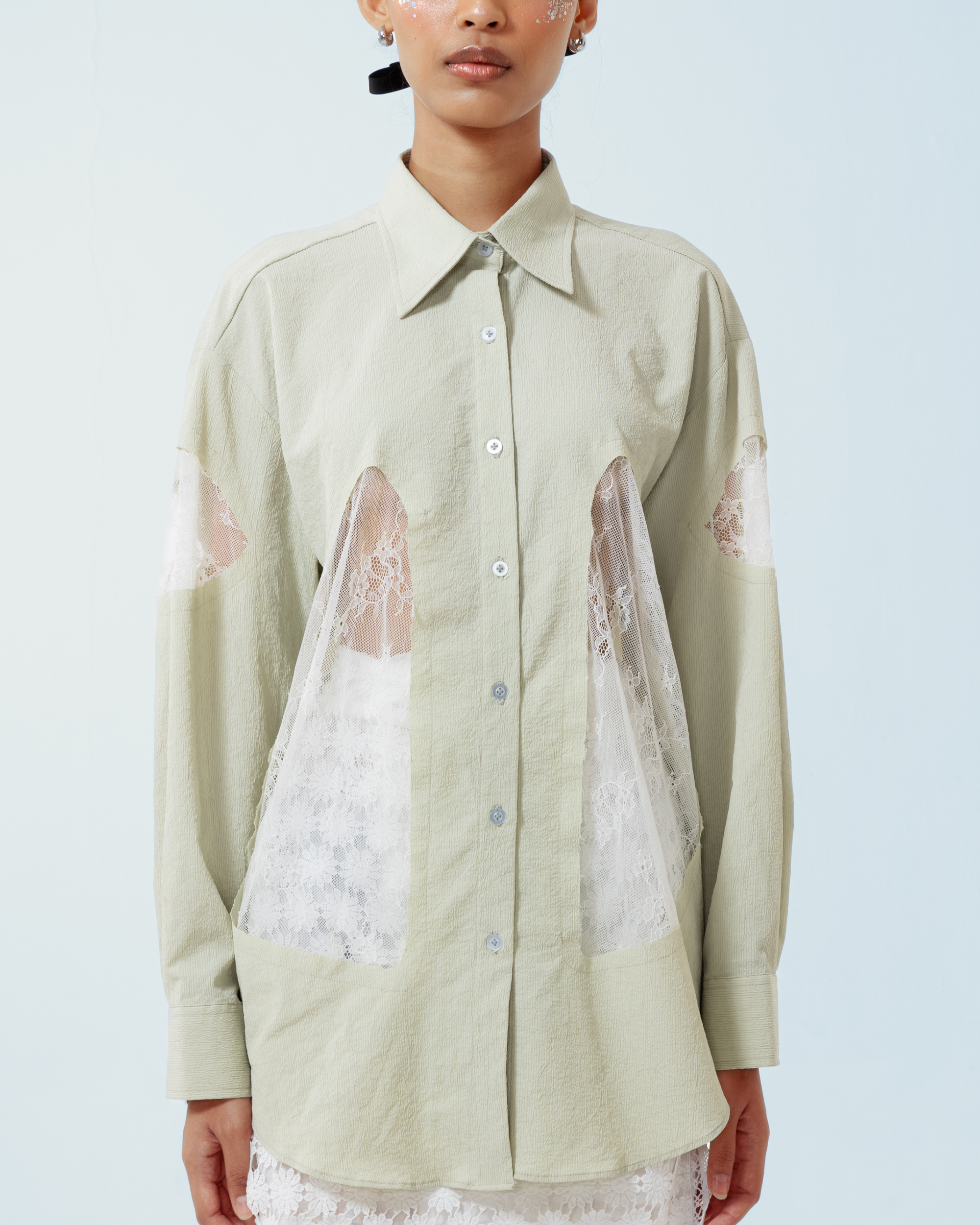 Image of Yoko Shirt Green, a longsleeve shirt made from cotton crepe, features a contrast lace cut-out details along both sides and the sleeves.