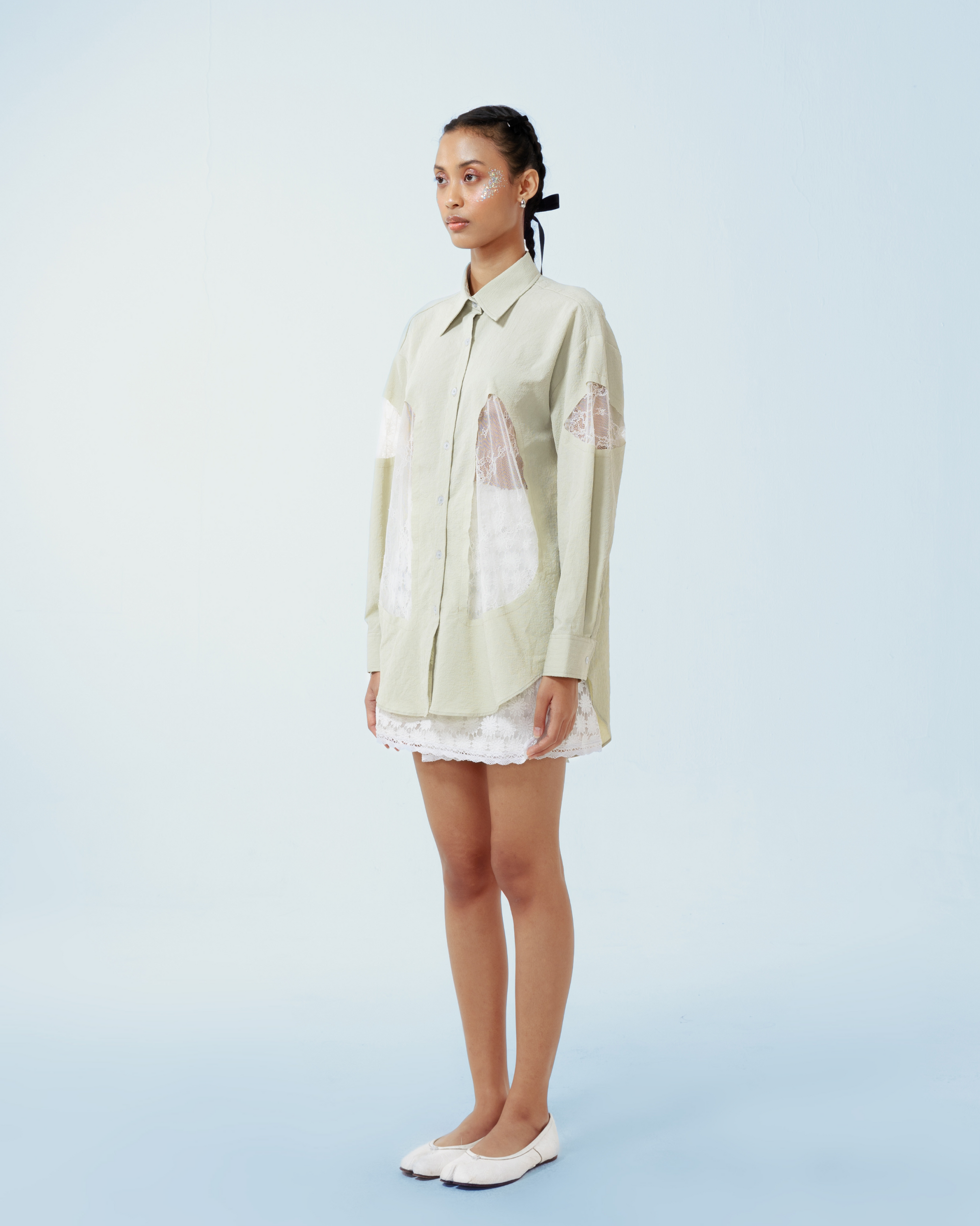 Image of Yoko Shirt Green, a longsleeve shirt made from cotton crepe, features a contrast lace cut-out details along both sides and the sleeves.