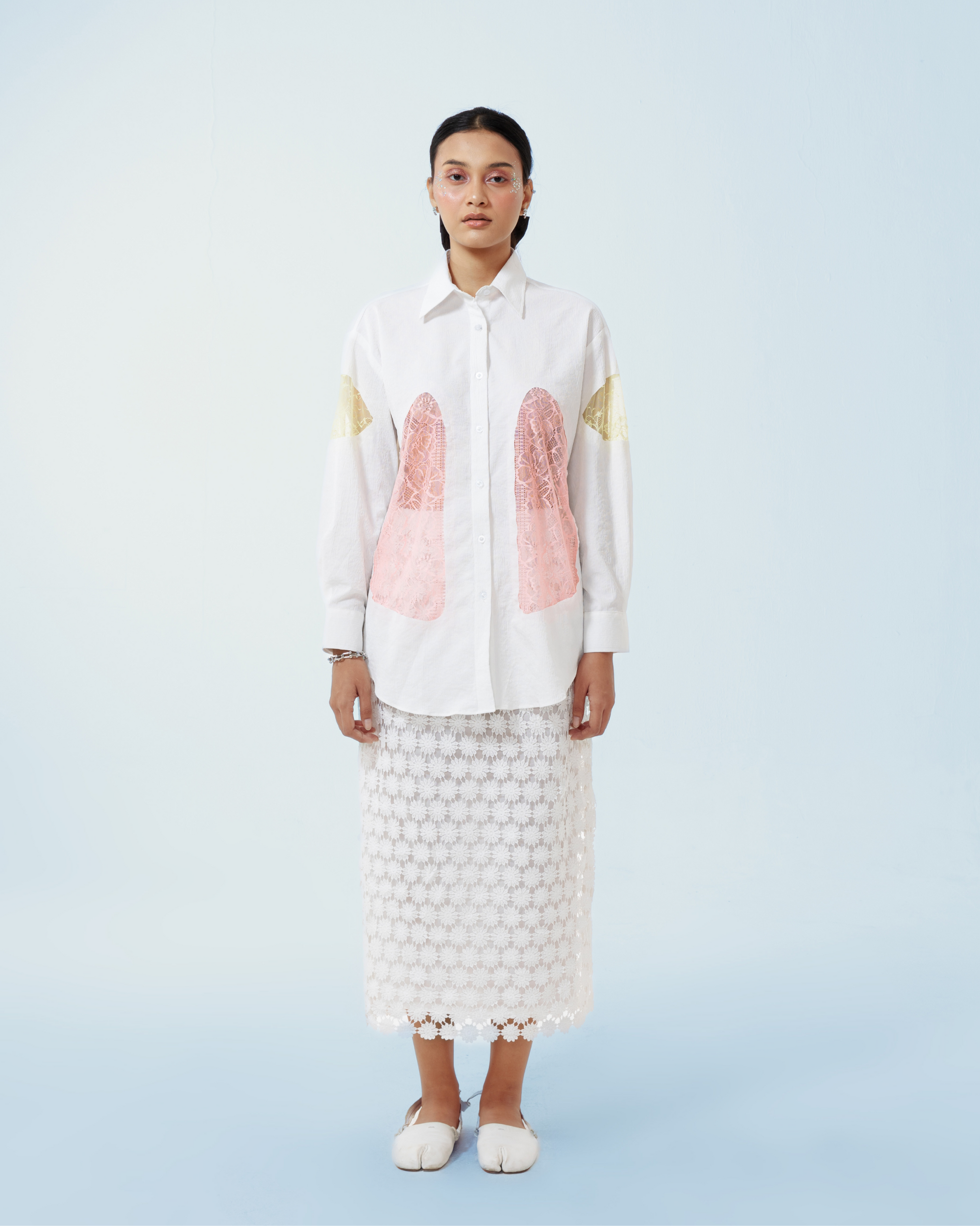 Image of Yoko Shirt White, a longsleeve shirt made from cotton crepe, features a contrast lace cut-out details along both sides and the sleeves.